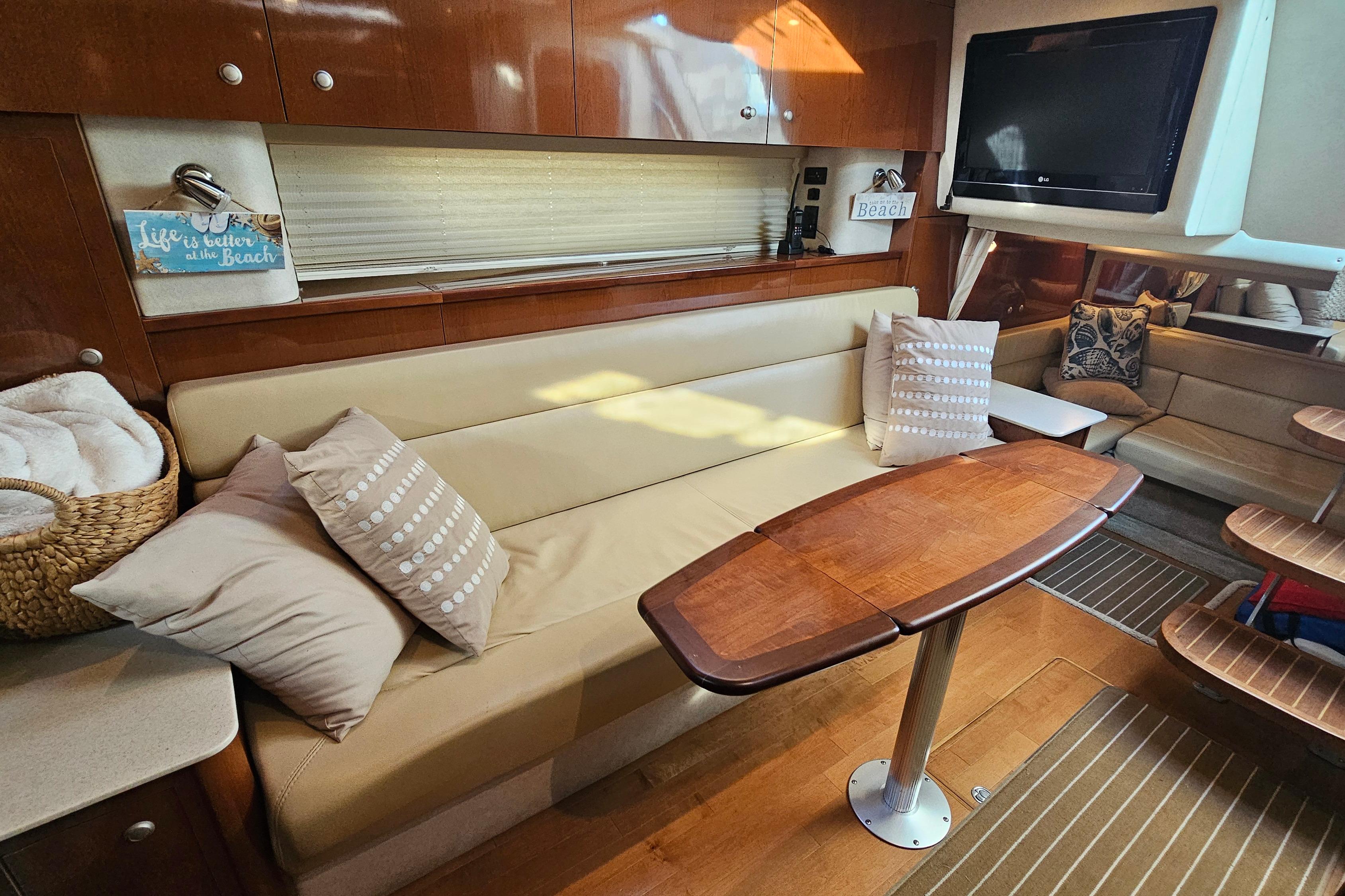 Luxurious interior of 2008 Sea Ray Sundancer 350 yacht with cozy seating and elegant decor.