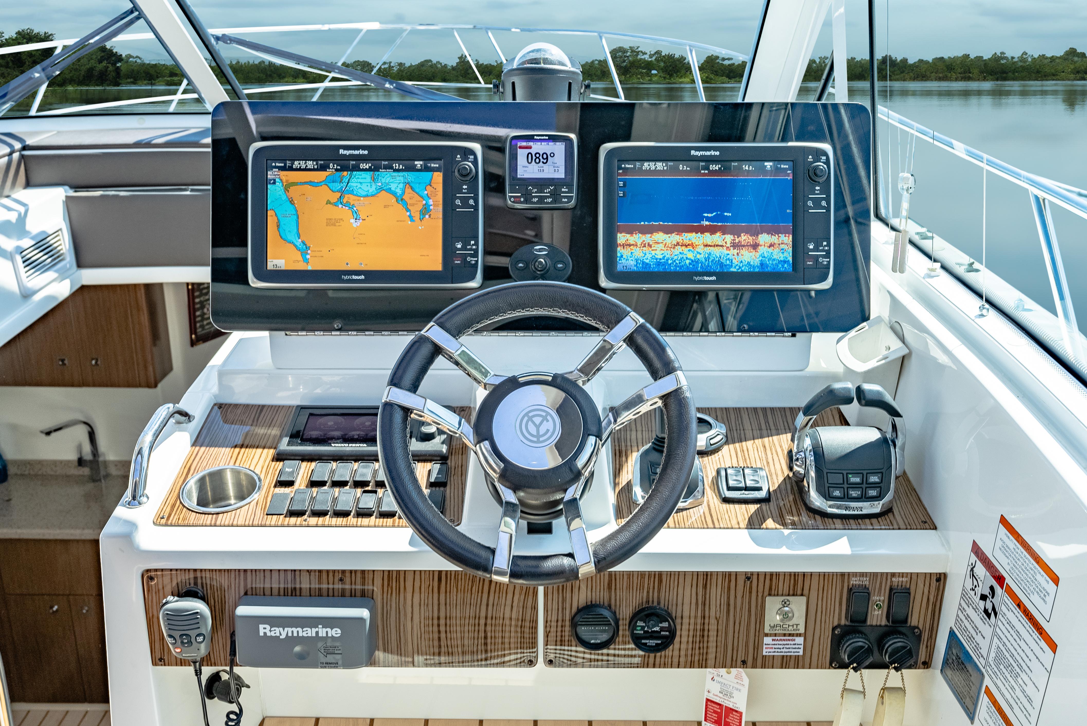Helm of 2013 Cruisers Yachts 48 Cantius with navigation displays and controls.