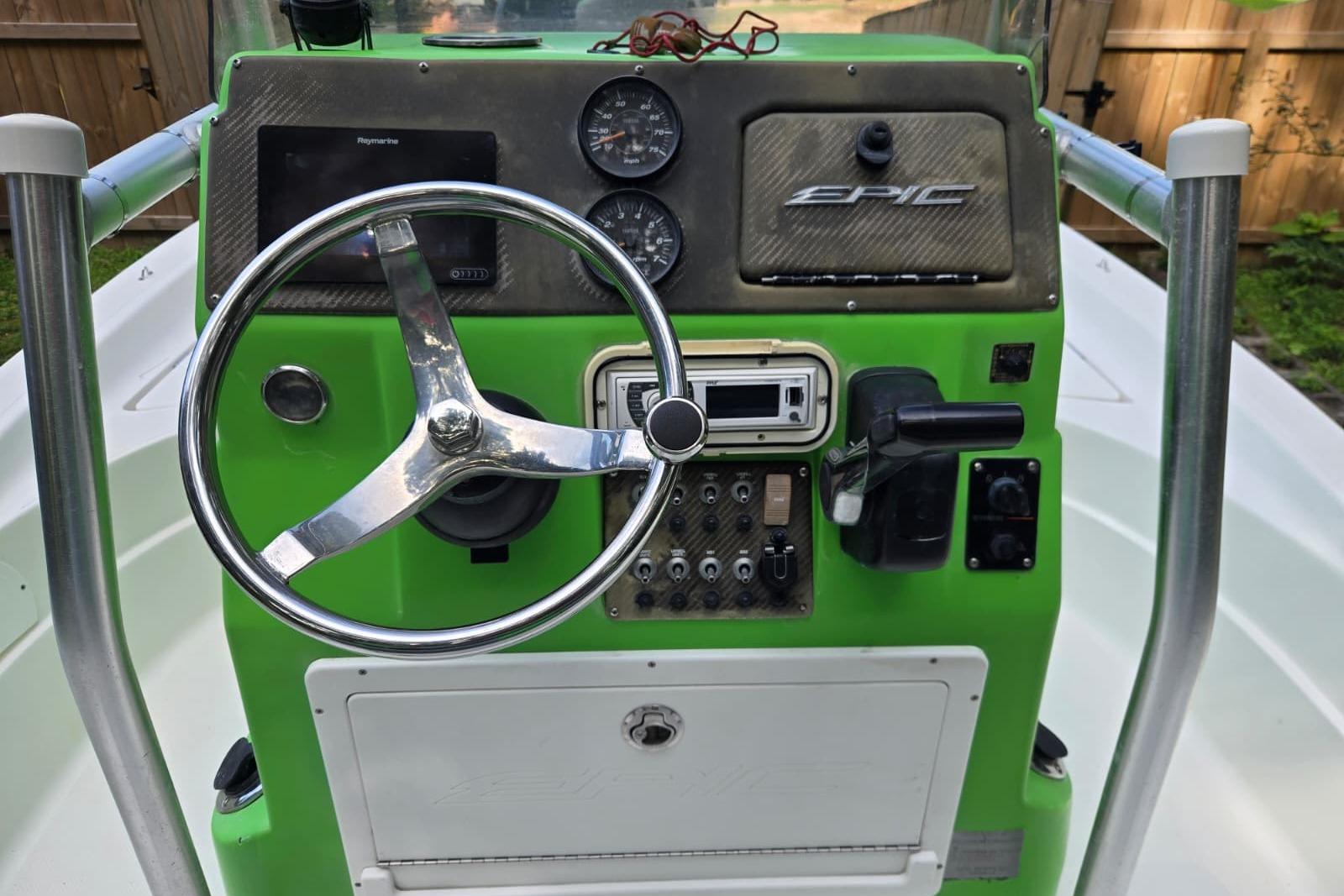 2016 Epic 21 Sport Console boat dashboard with steering wheel and controls.