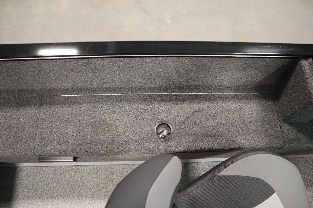 2026 Lowe Fishing Machine 175 interior storage compartment with gray carpeting and seating.