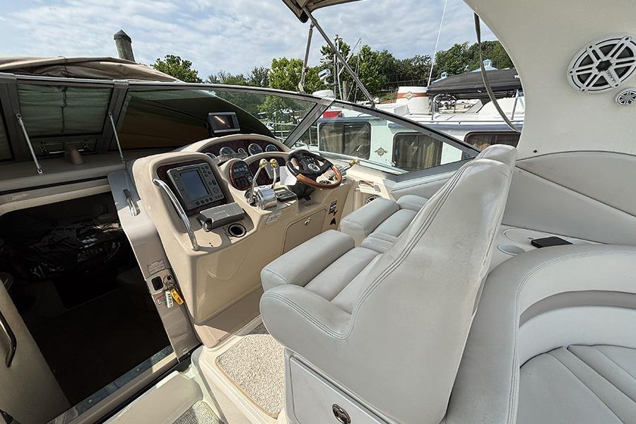 Interior cockpit of 2002 Sea Ray Sundancer 320 with steering wheel and navigation controls.
