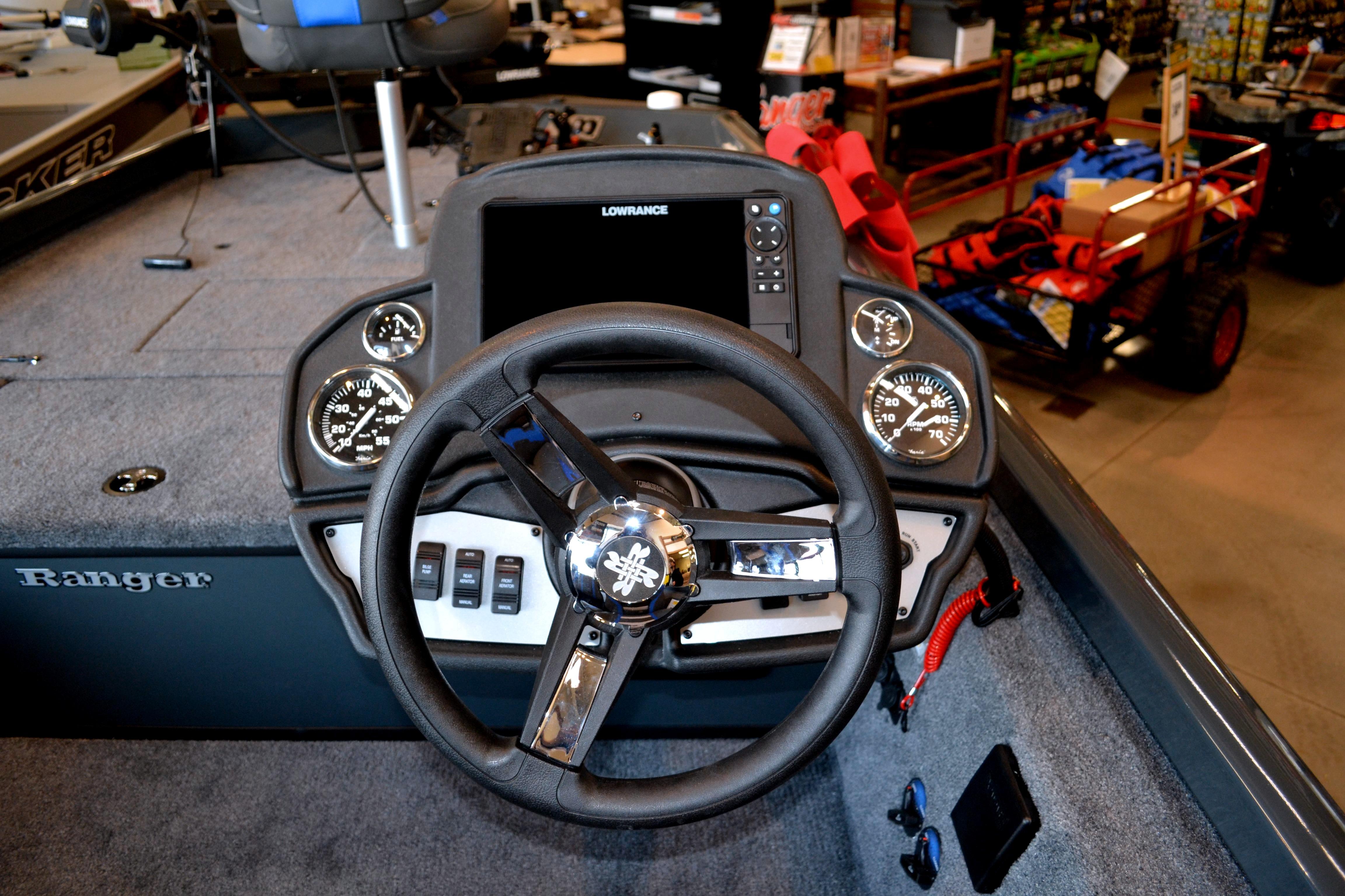 2026 Ranger RT178C boat dashboard with steering wheel and gauges in showroom.