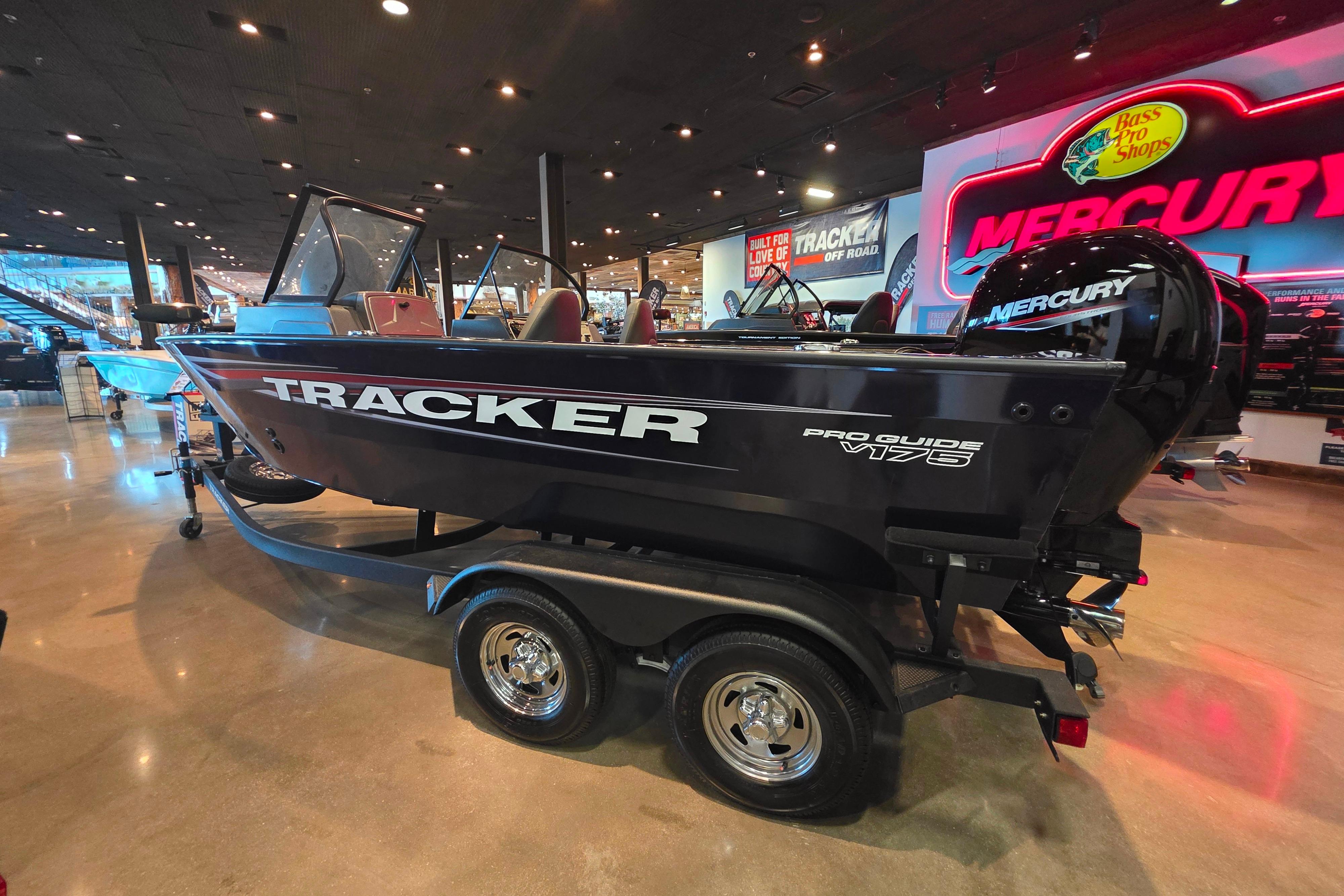2026 Tracker Pro Guide V-175 Combo boat displayed indoors with Mercury engine.