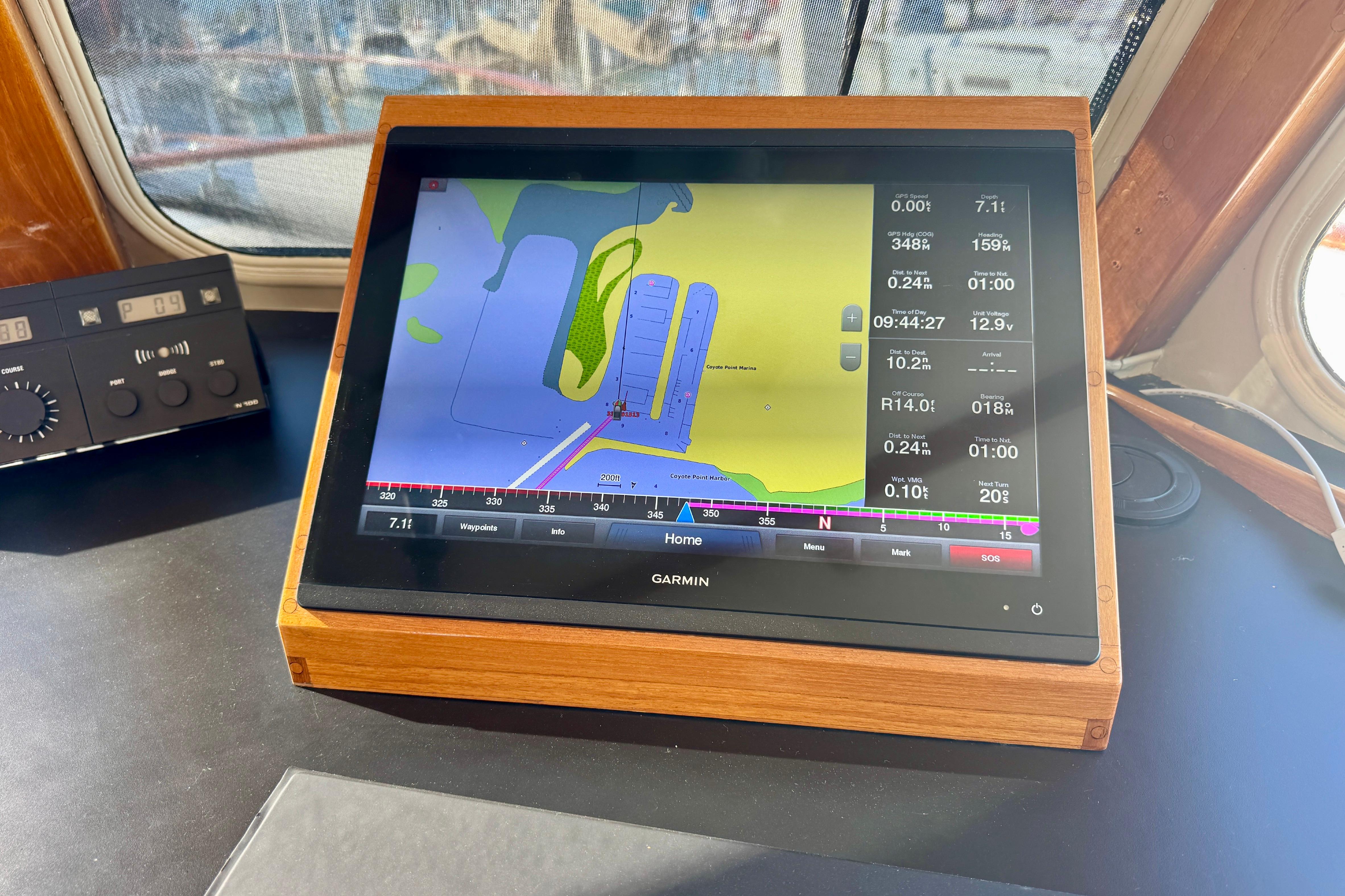 Pilothouse navigation system on a 1958 Blanchard boat, featuring a Garmin display.
