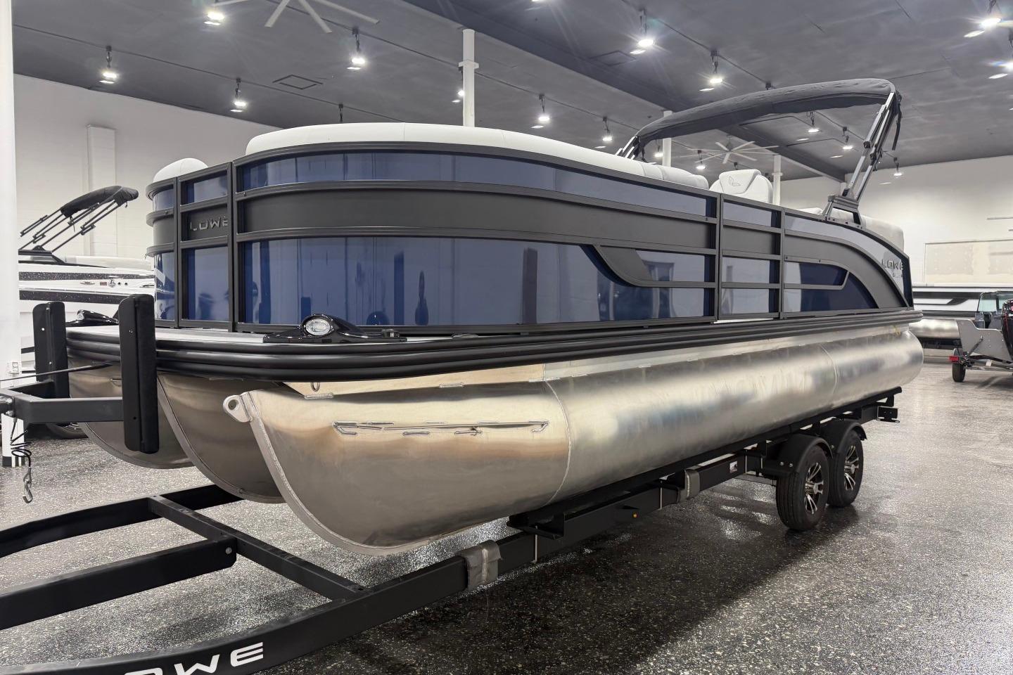 2026 Lowe SS 230 WT pontoon boat in showroom, featuring sleek design and modern amenities.