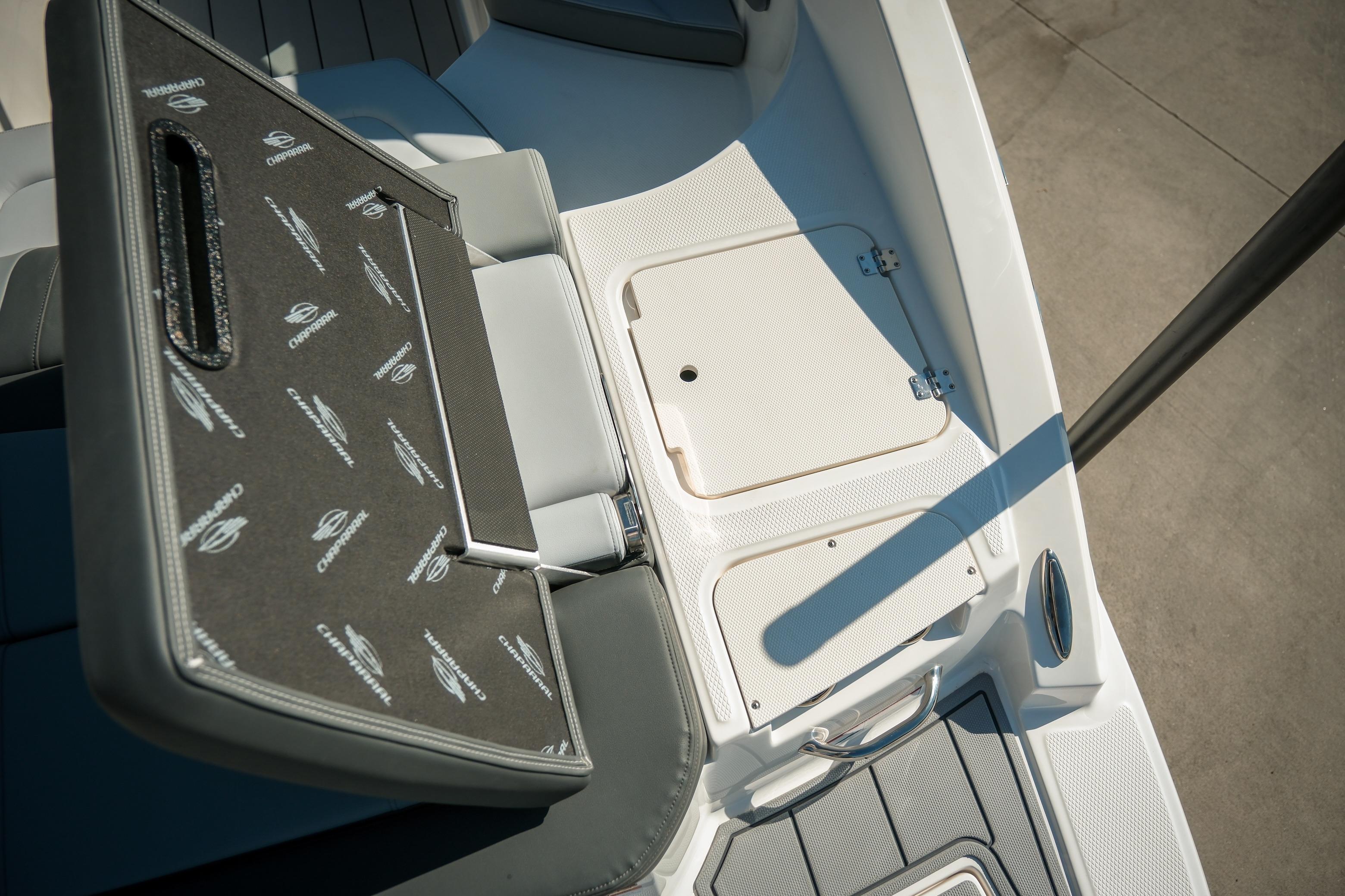 2026 Chaparral 23 SSi boat interior with storage compartments and seating.