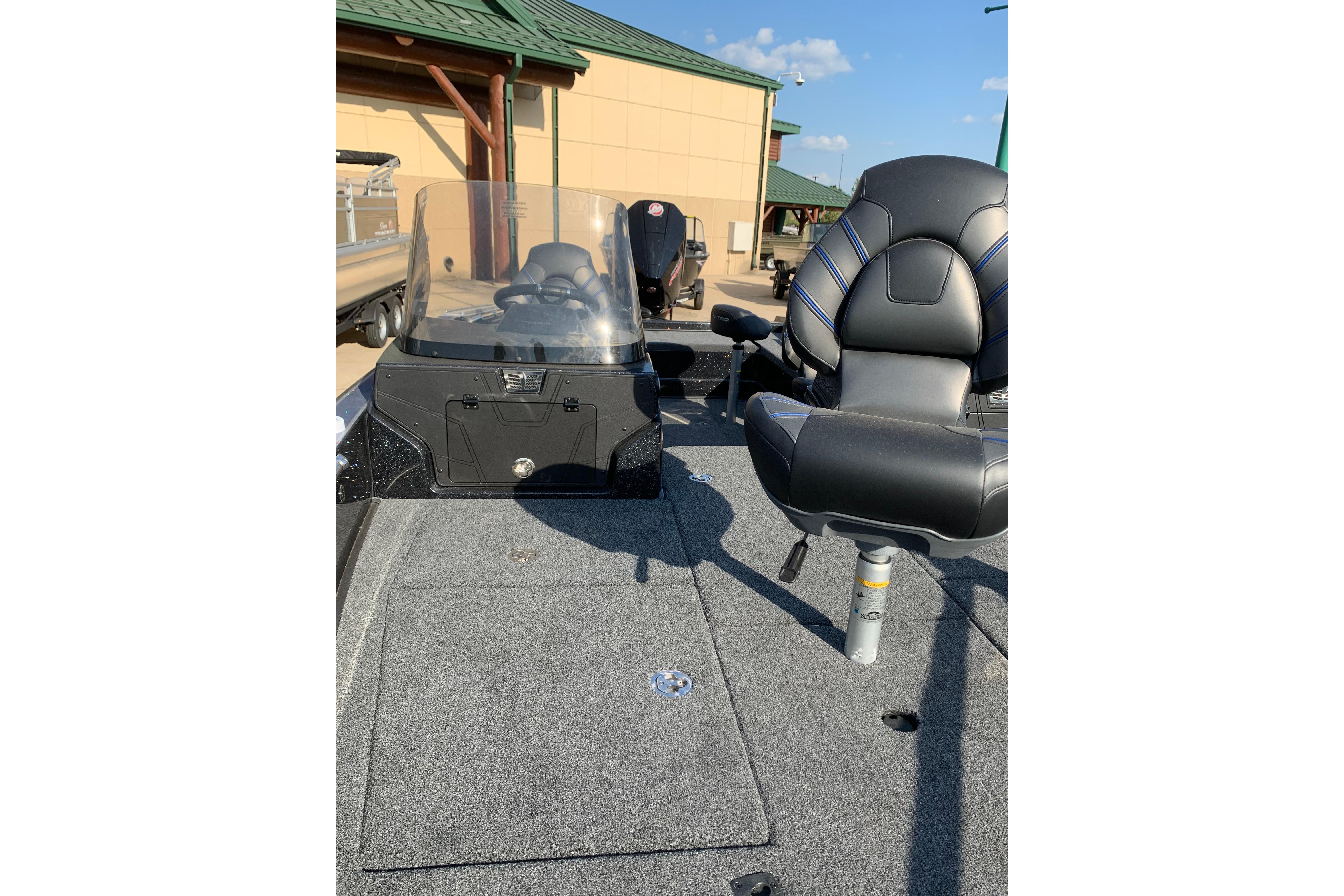 2025 Nitro ZV20 boat interior with seating and console, parked outdoors.