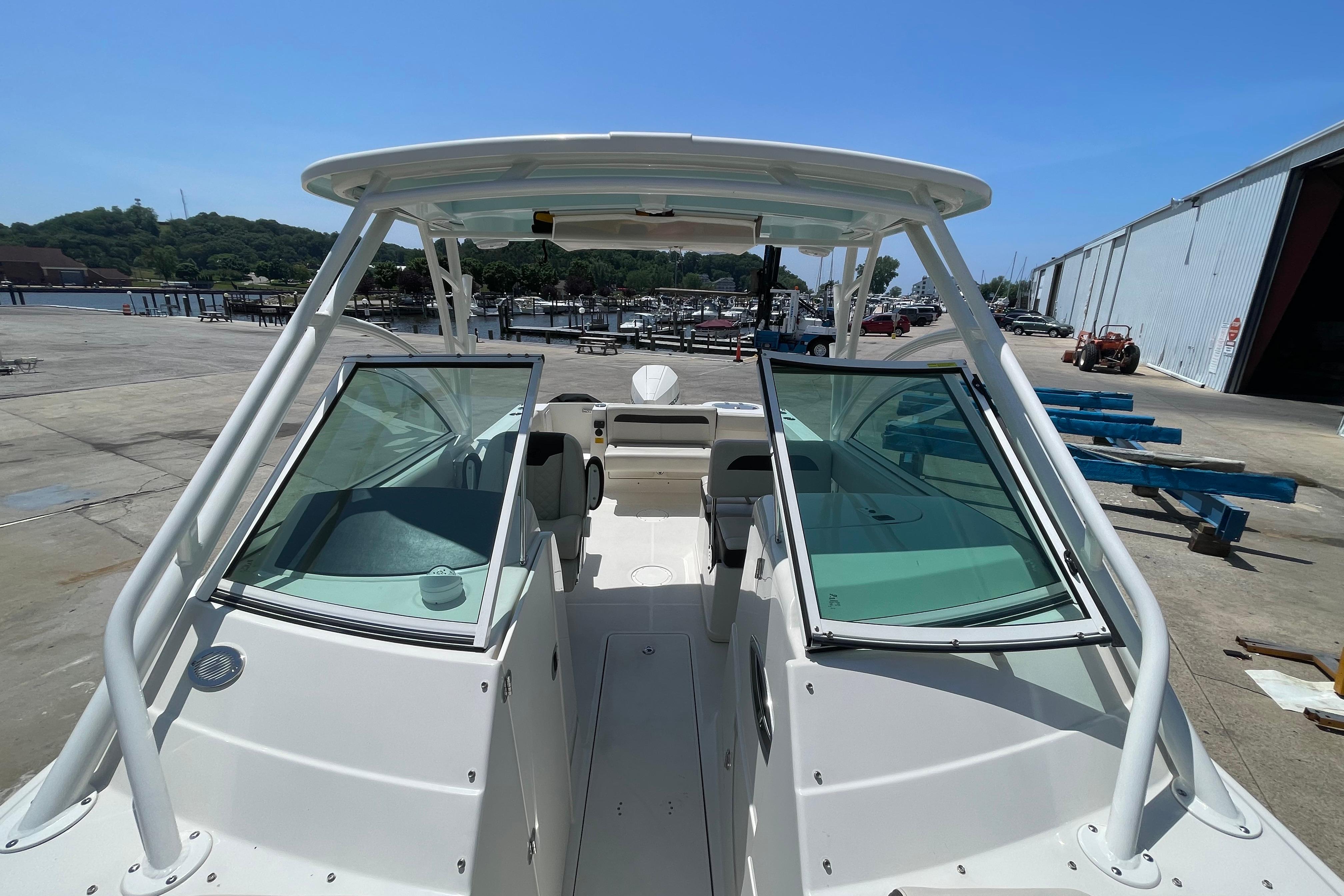 2022 Sailfish 245 DC boat docked, featuring dual consoles and a spacious deck.