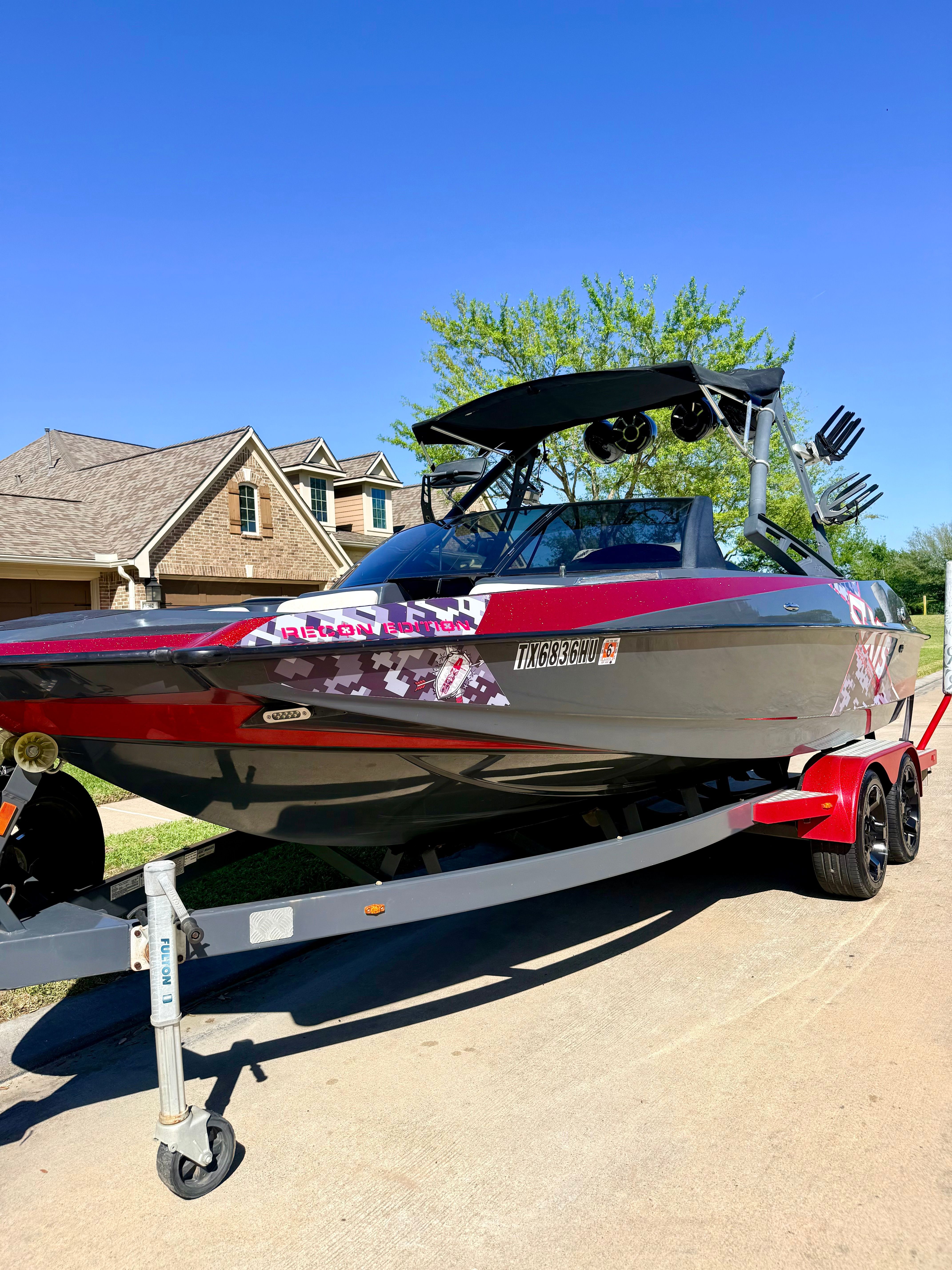 2013 Axis A22 boat on trailer, sunny day, residential area.