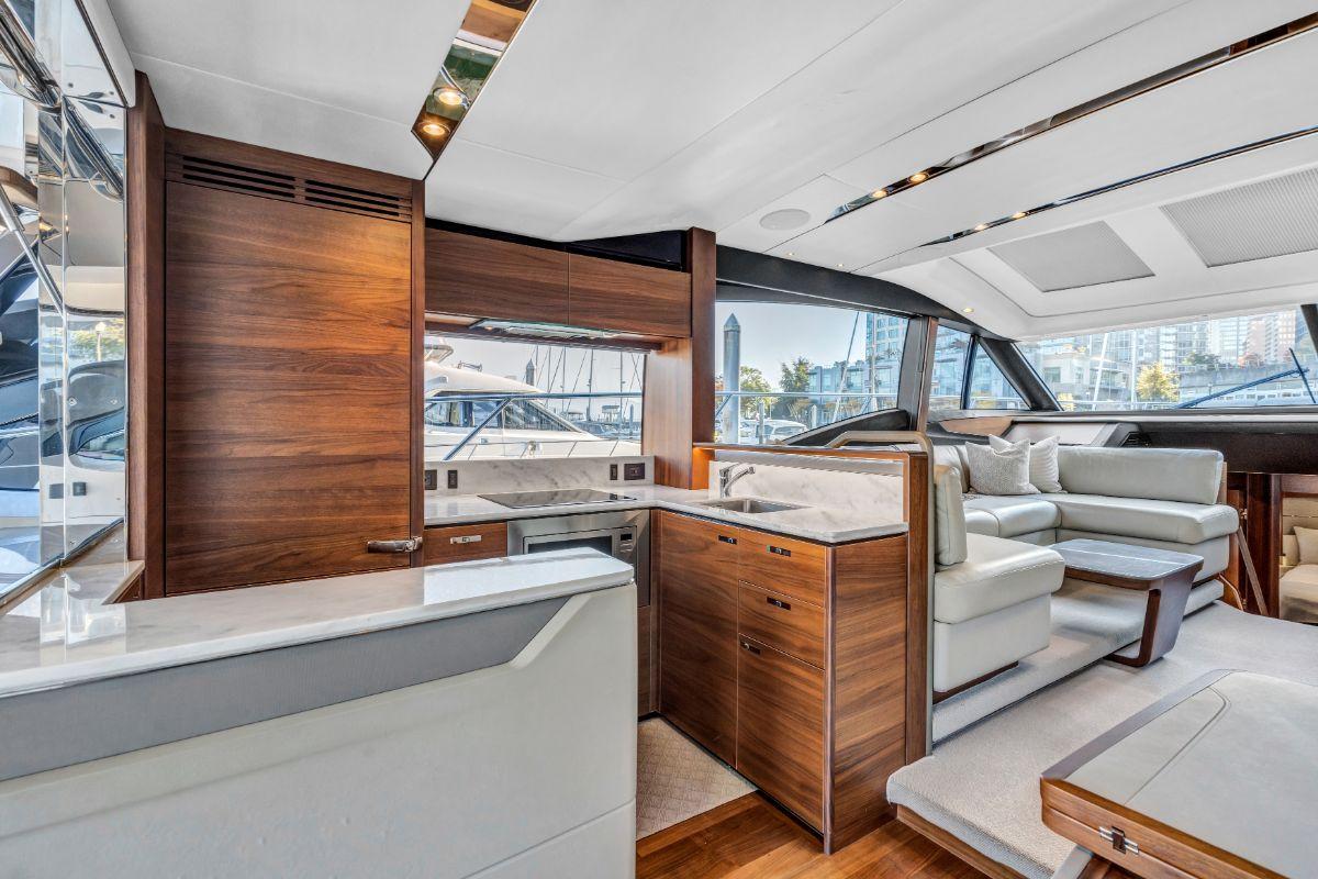 Luxurious interior of a 2018 Princess S60 yacht with elegant wood finishes and modern seating.