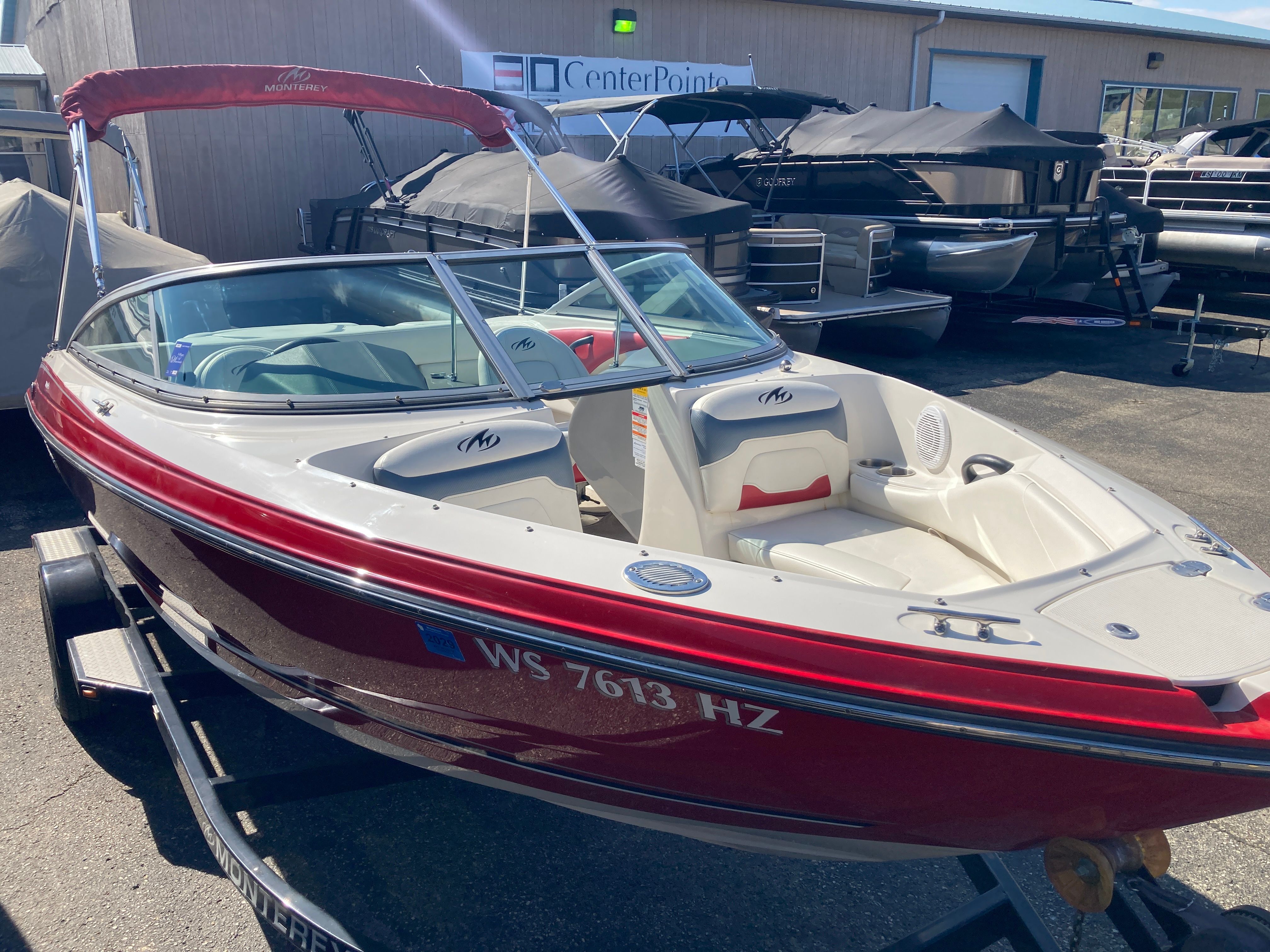 2012 Monterey 204FS boat, red and white, on trailer.