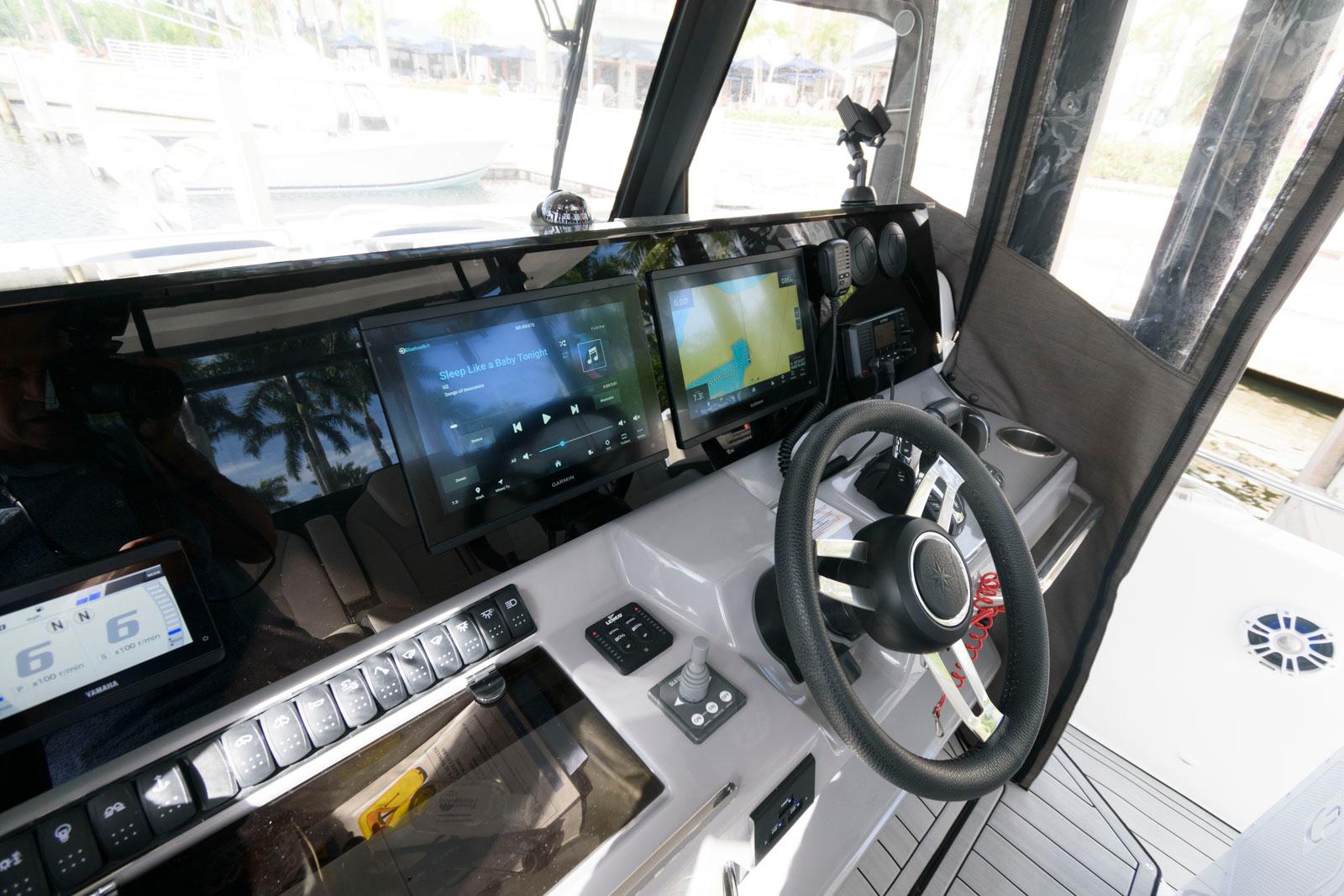 2023 Jeanneau Leader 10.5 CC cockpit with modern navigation displays and steering wheel.