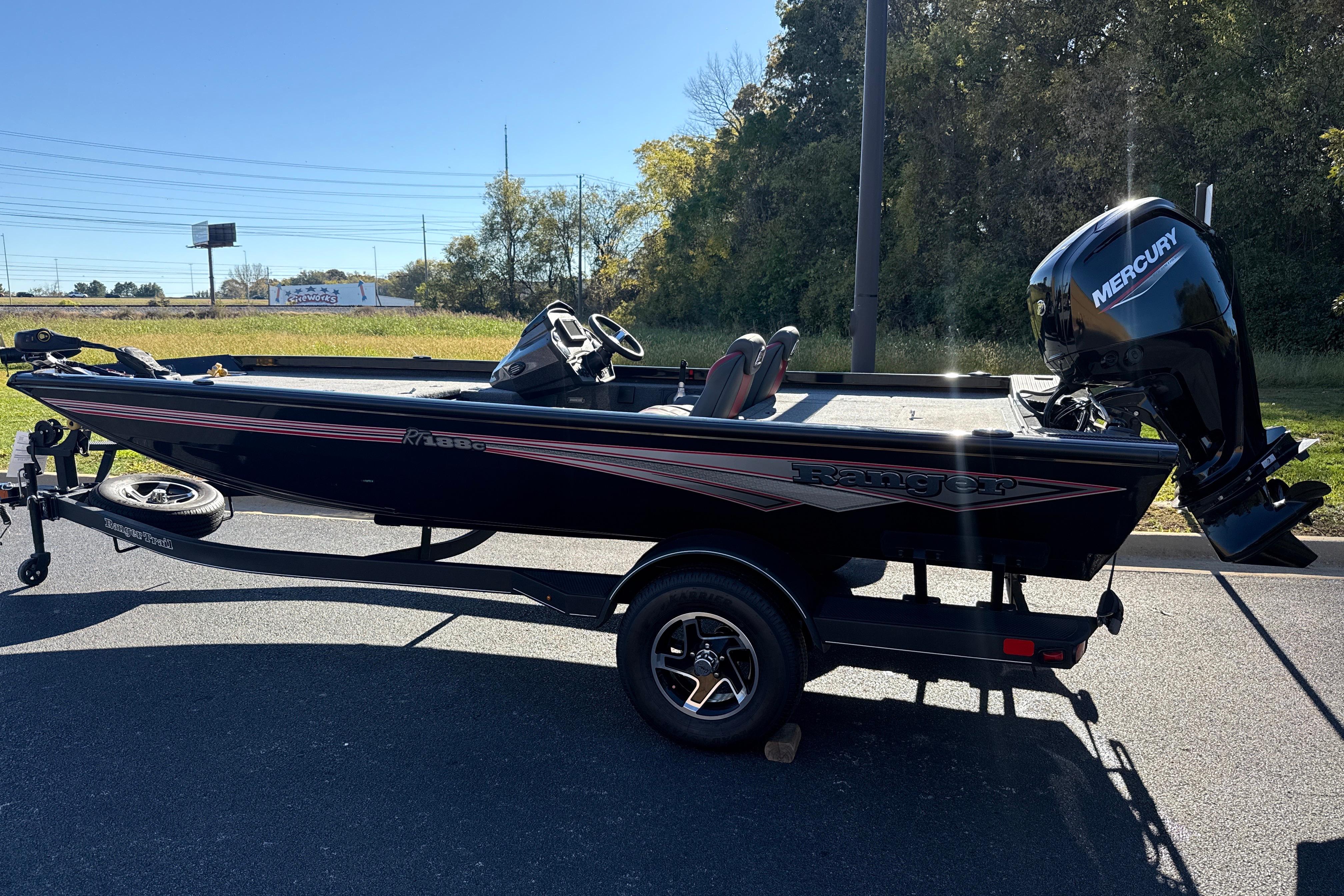 2025 Ranger RT188C boat with Mercury engine on trailer, parked outdoors.