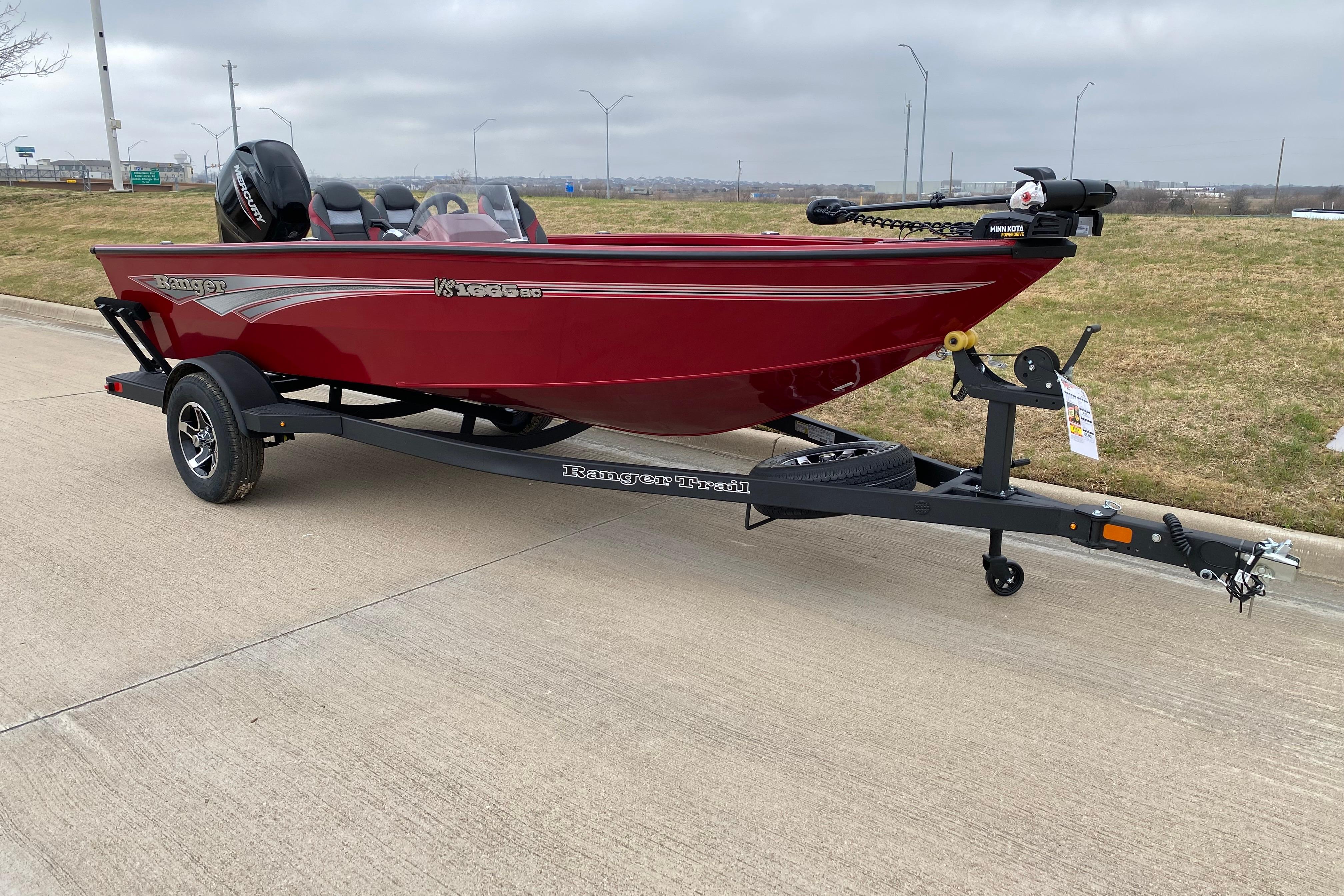 2026 Ranger VS1665SC boat on trailer, red exterior, parked on concrete pavement.