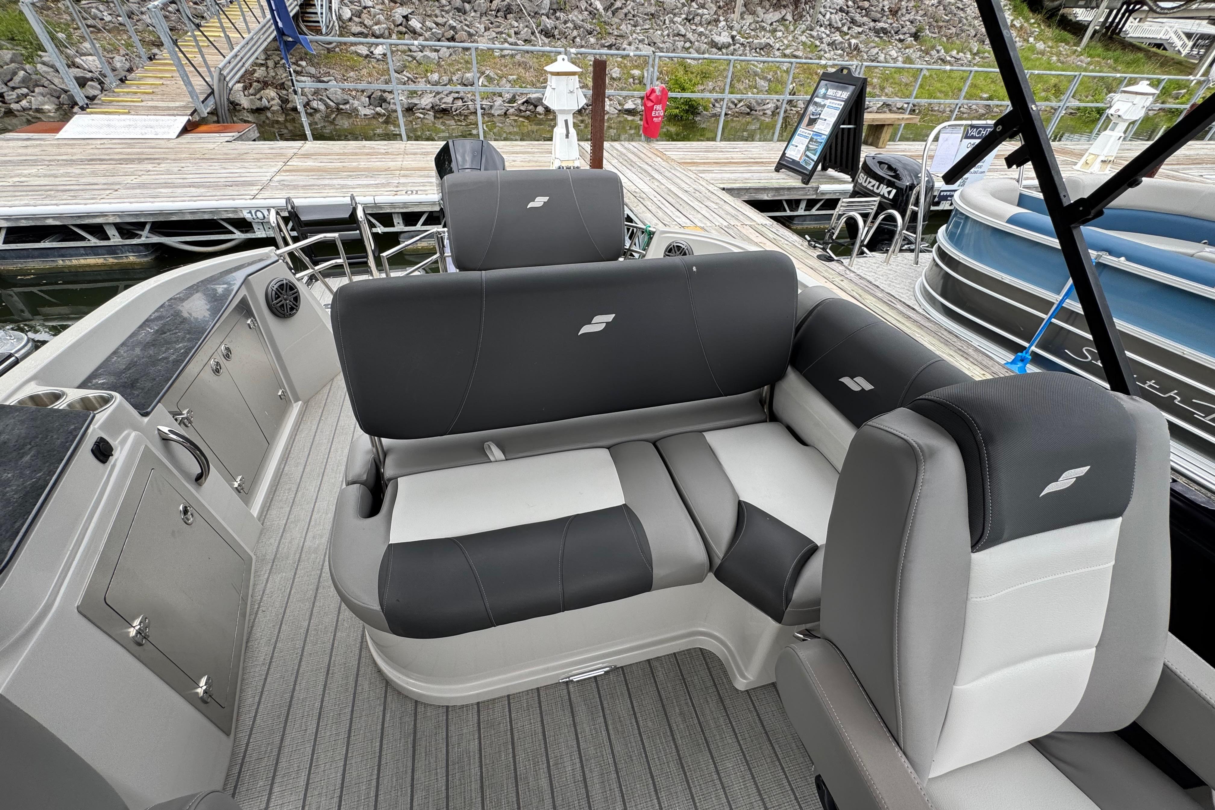 2023 Starcraft MX 25 DL DH boat interior with gray seating at a dock.