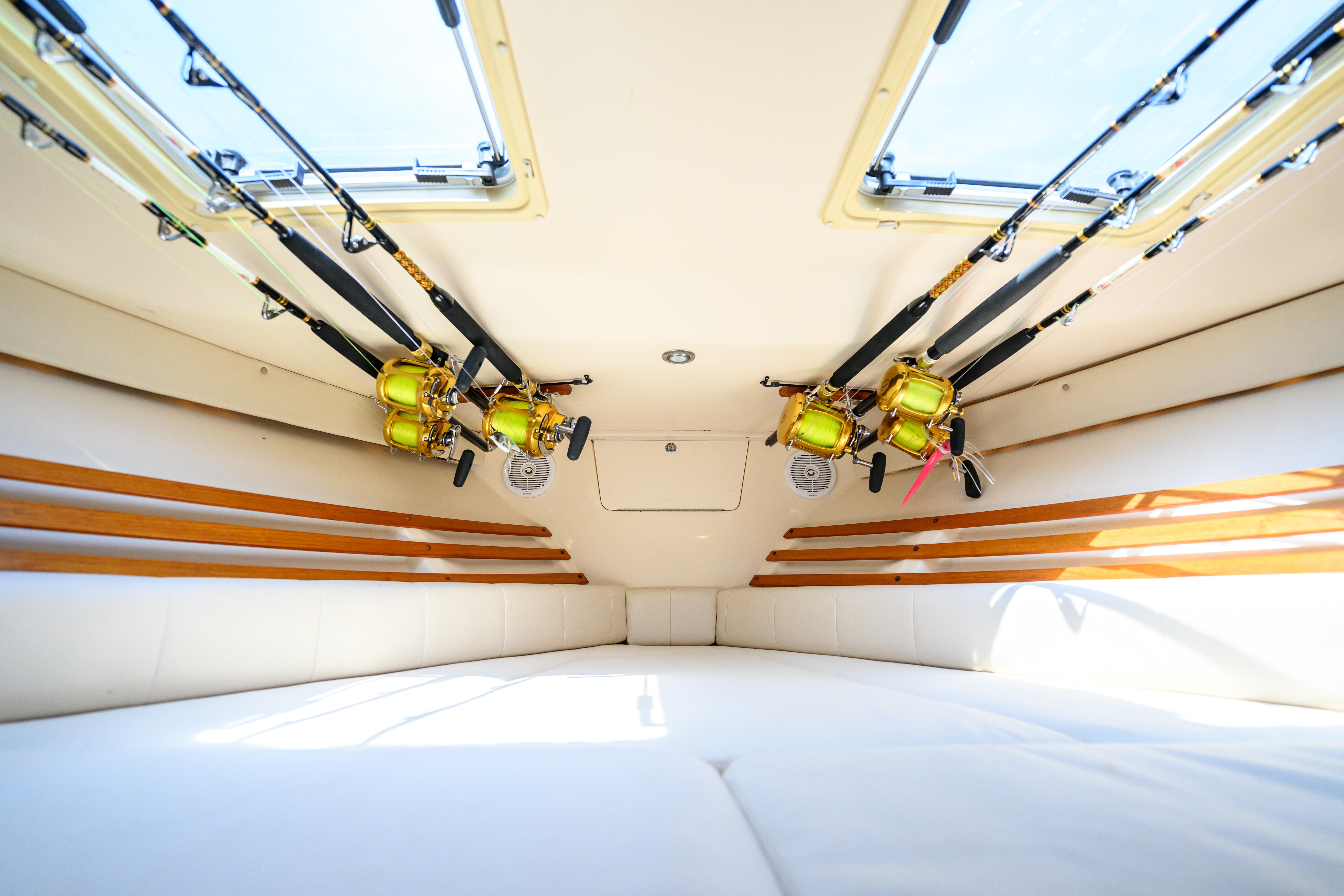 Interior of 2003 Grady-White Express 330 boat with fishing rods stored overhead.