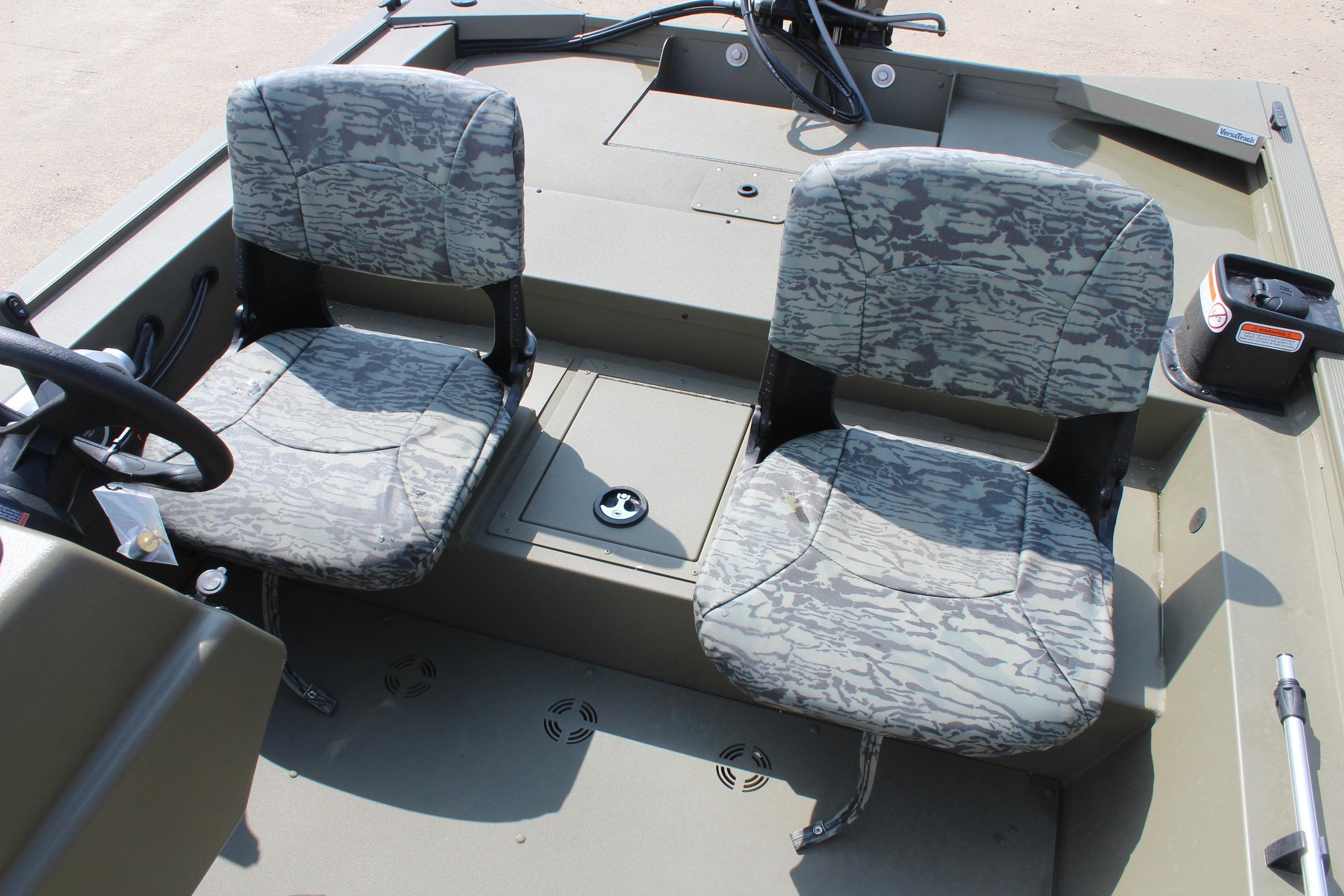 2026 Tracker Grizzly 1754 SC boat interior with camouflage seats and steering console.