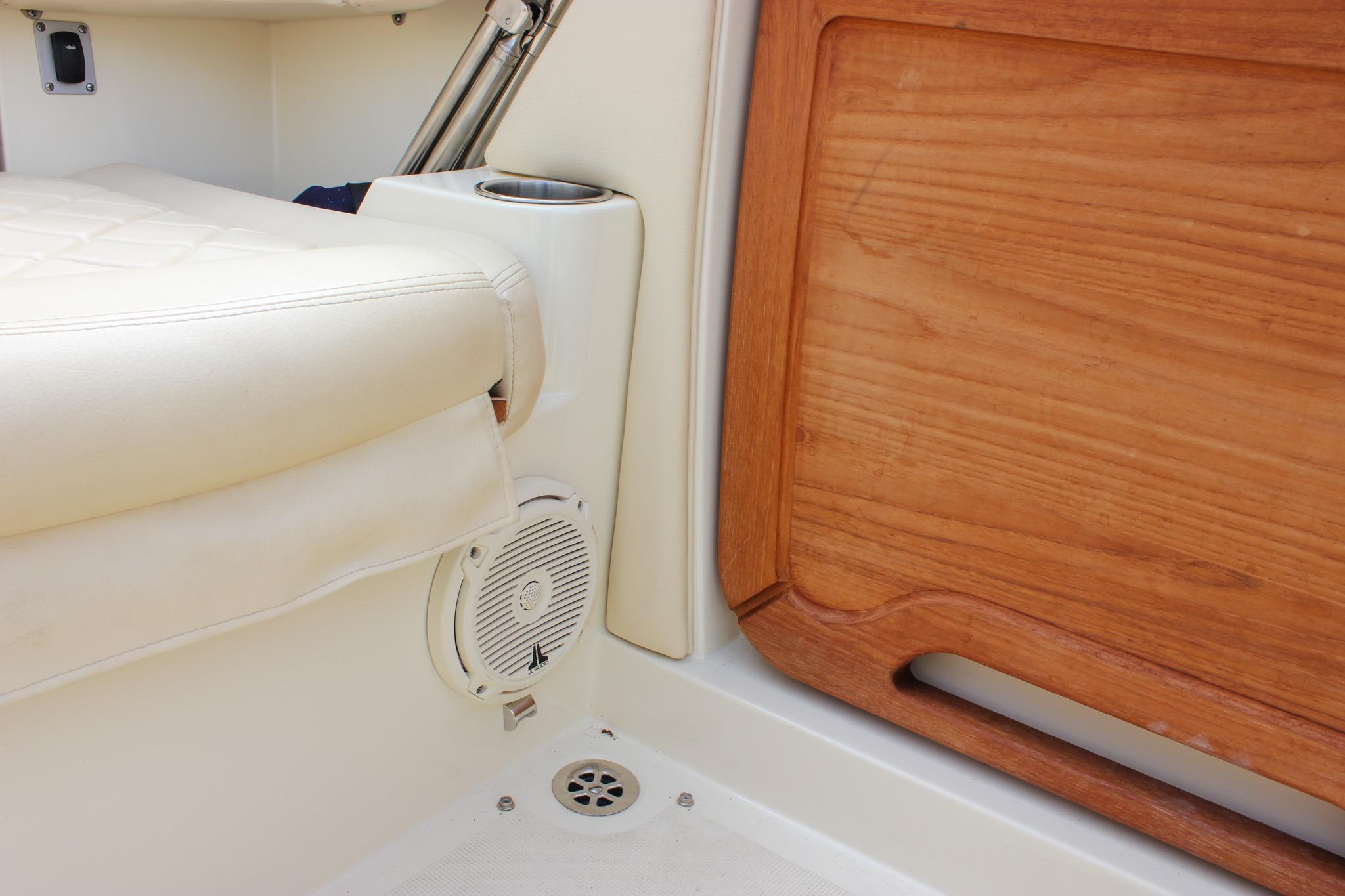 Interior of 2017 Chris-Craft Capri 27 boat, featuring white seating and wooden paneling.