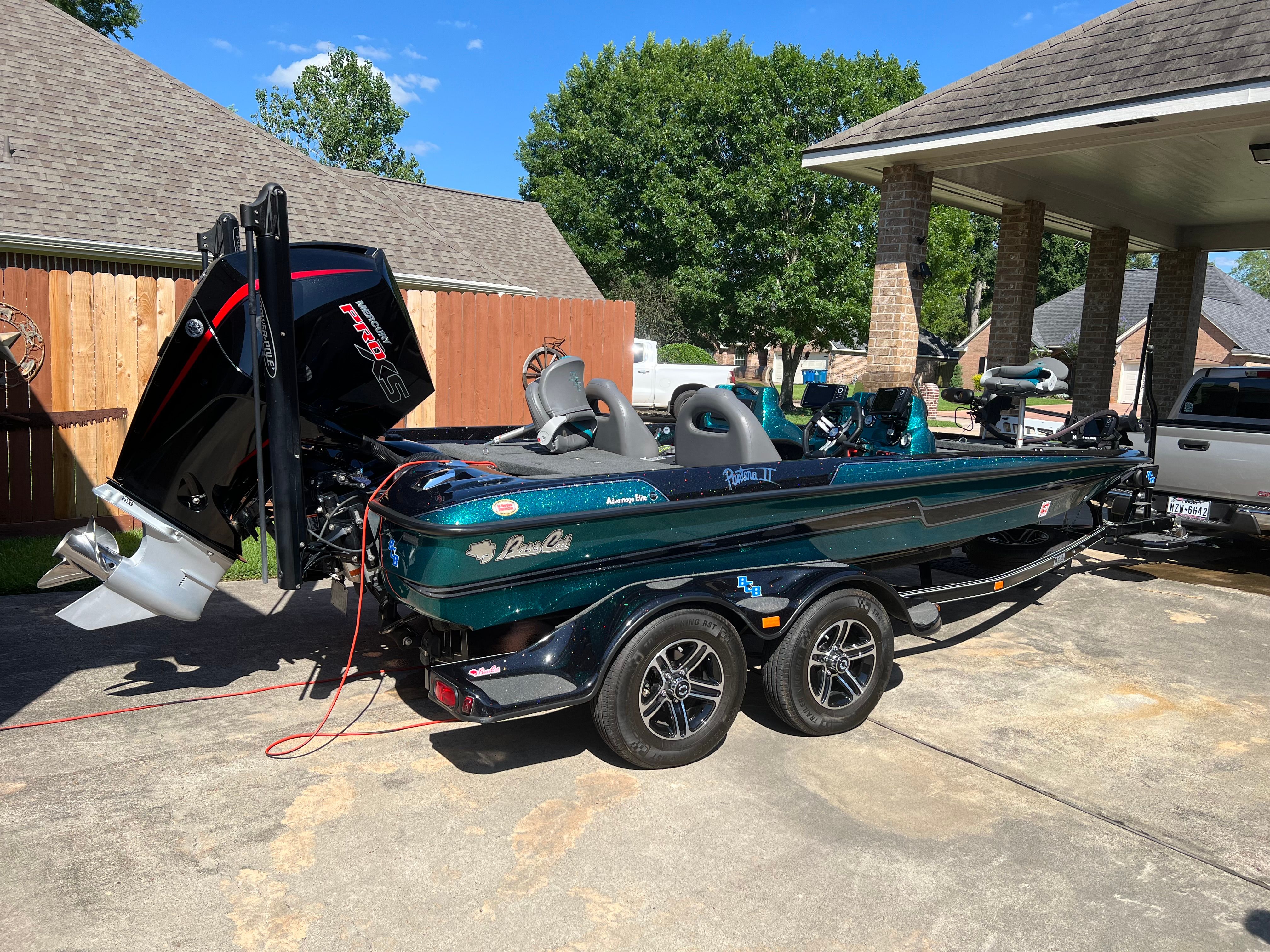 A 2020 Bass Cat Pantera II boat on a trailer in a driveway.