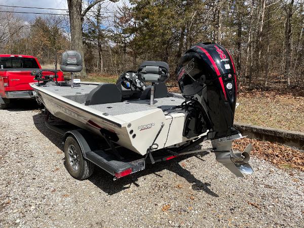 2021 Tracker Pro 195 XTE boat on trailer, parked outdoors near trees.