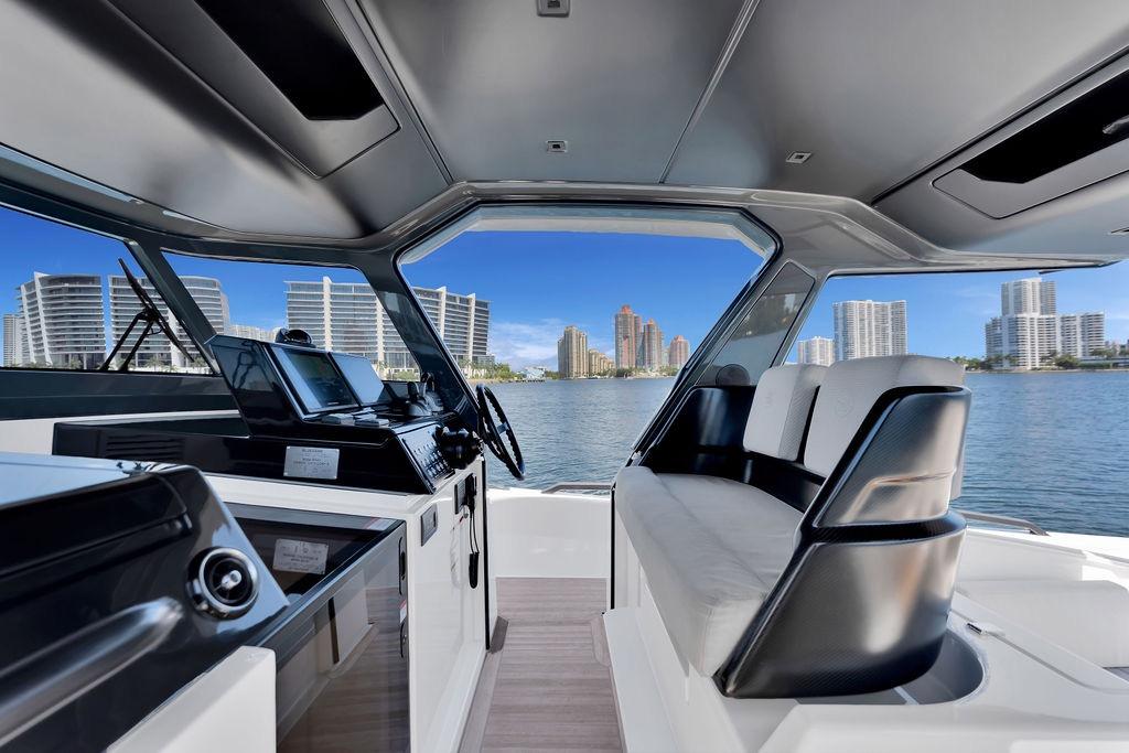 Interior view of 2021 Bluegame BG 42 yacht with city skyline in background.