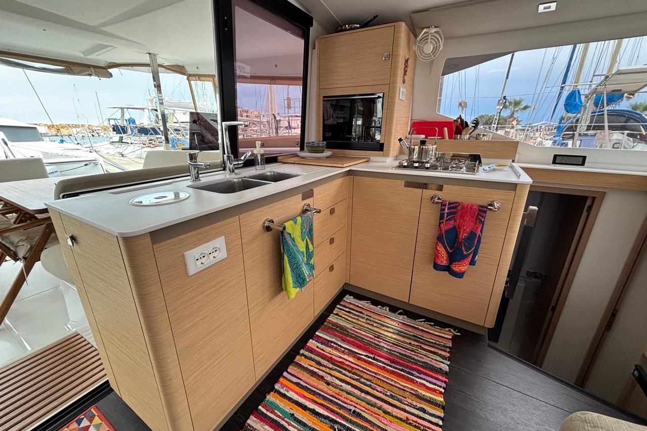 Modern kitchen interior of 2024 Fountaine Pajot Isla 40 catamaran with colorful decor.