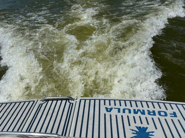 View from the boat's stern showing churning water.