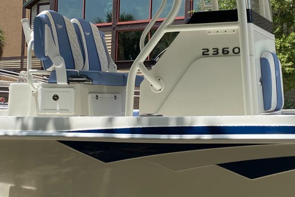 2025 Ranger 2360 Bay boat with blue and white seating, docked outdoors.