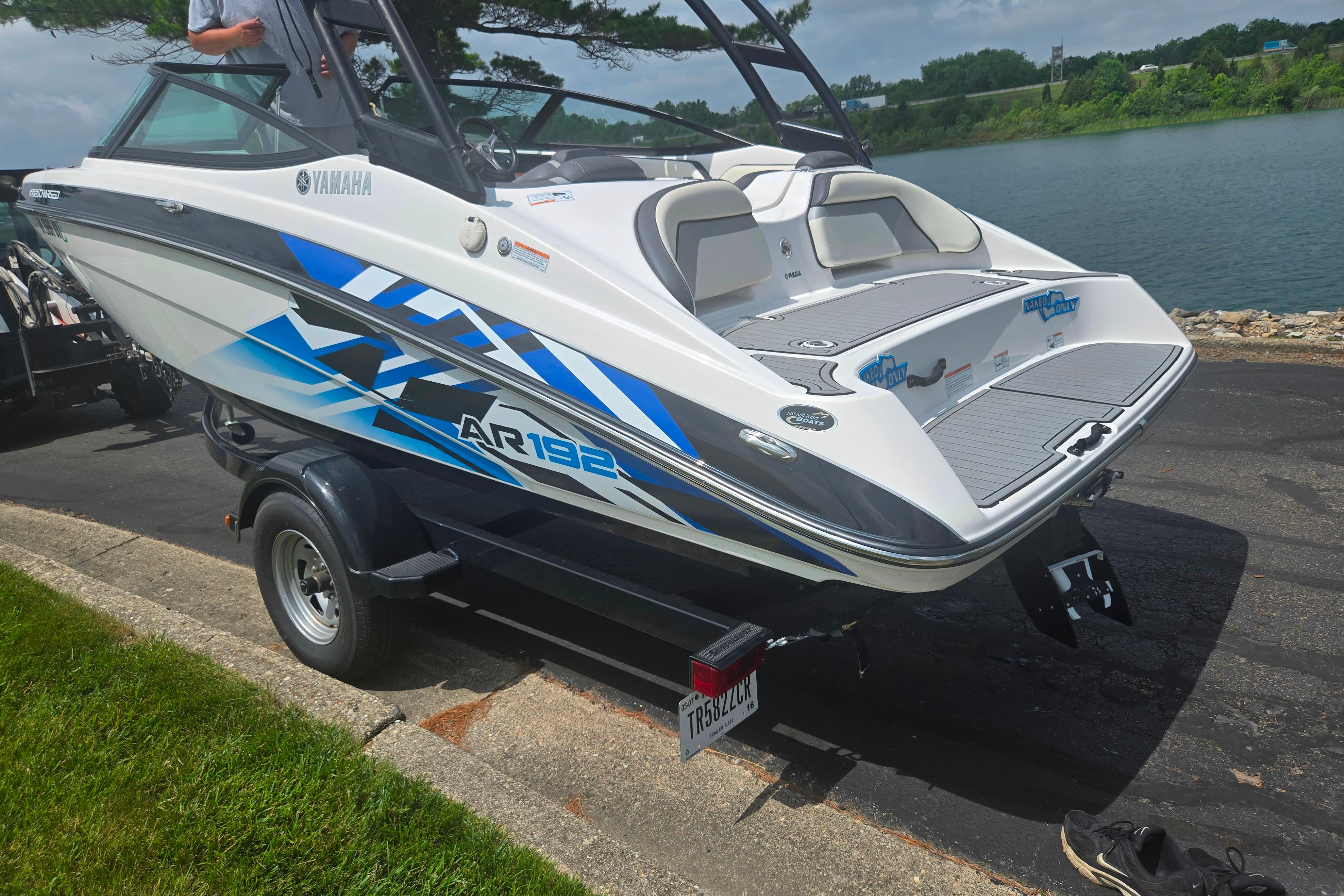 2016 Yamaha AR192 boat on trailer by a lake, featuring sleek design and vibrant graphics.
