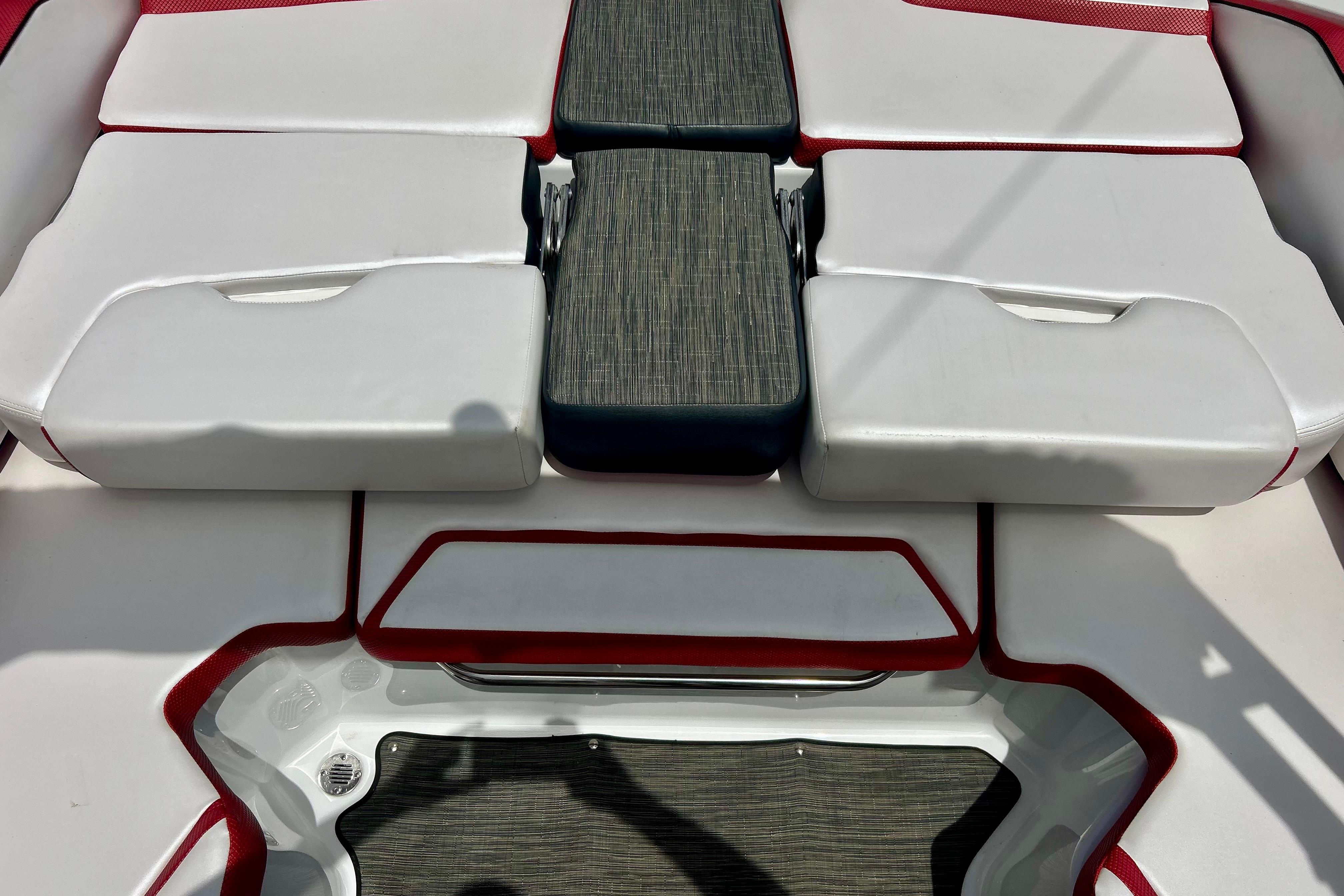 2021 Scarab 195 ID boat interior with white and red cushioned seating.