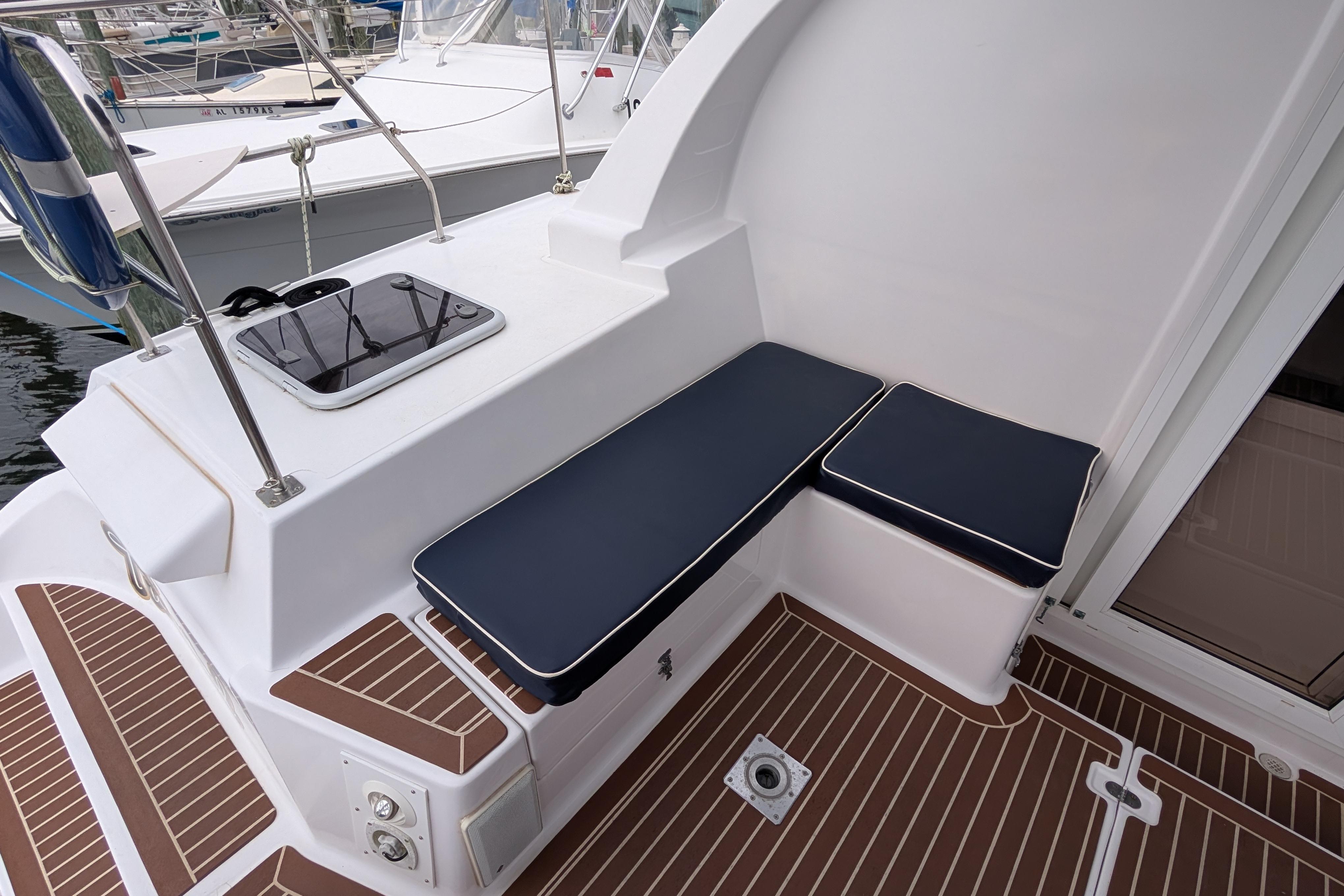 Island Spirit 37 yacht deck, 1999 model, featuring cushioned seating and sleek design.