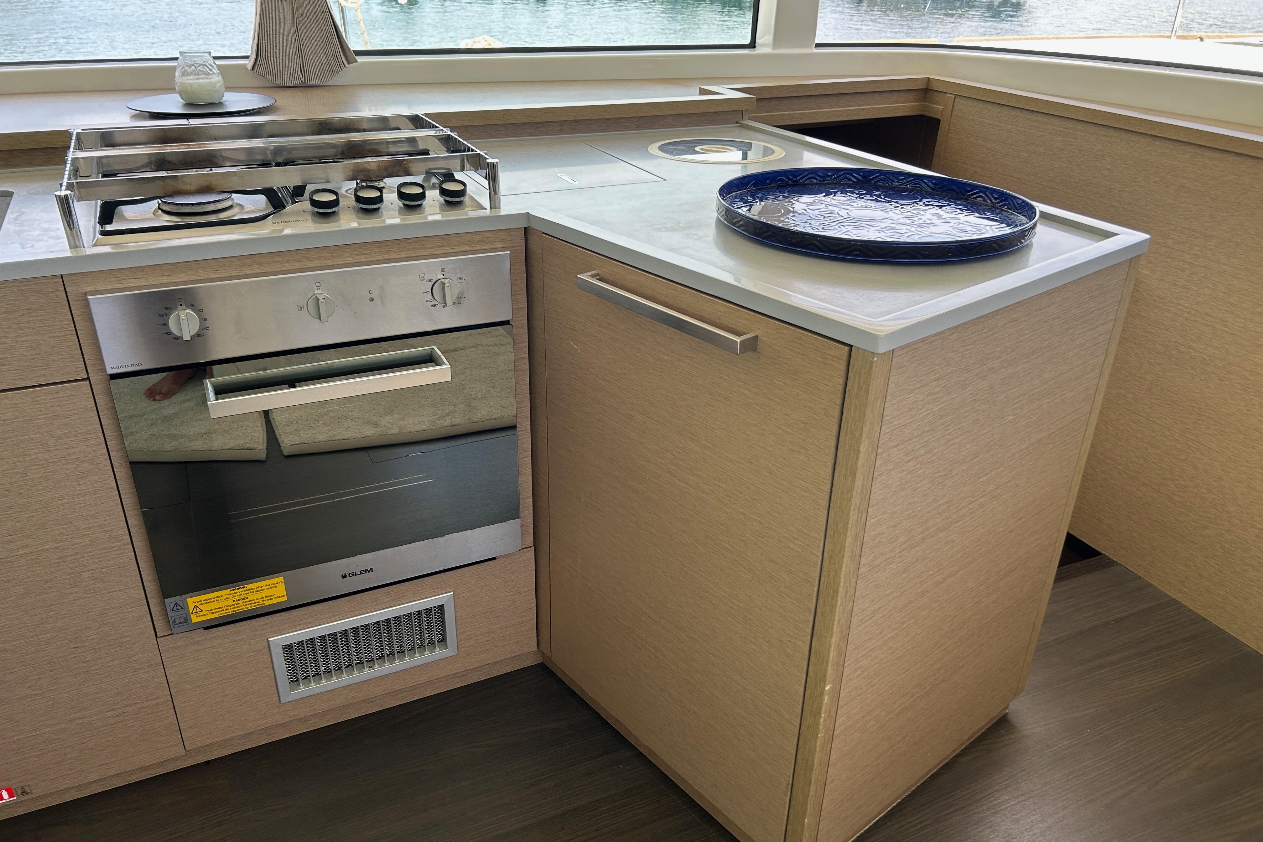 Modern kitchen in 2021 Lagoon 52 S yacht with stove and oven.