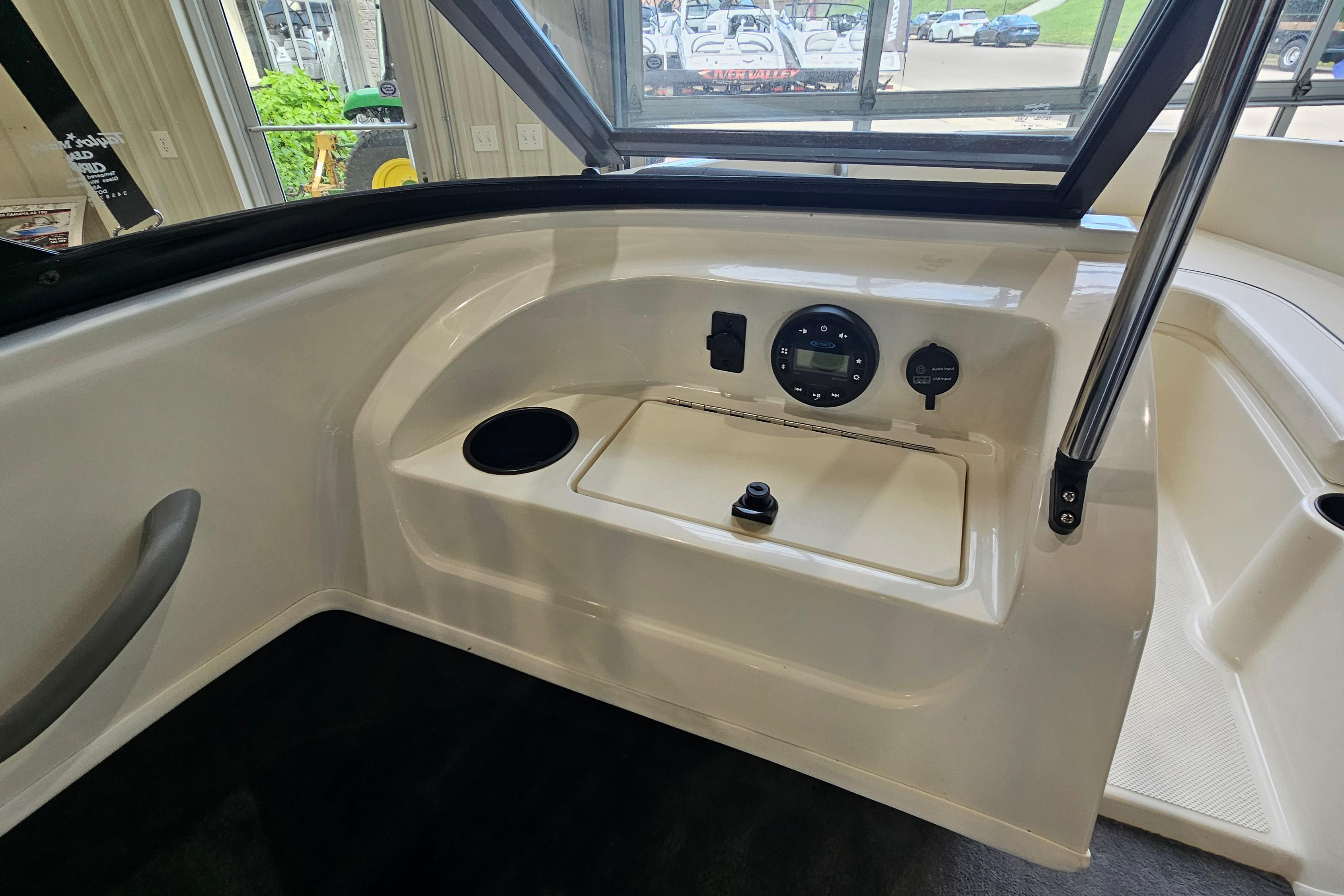 2019 Bayliner 170 Bowrider interior dashboard with controls and cup holder.