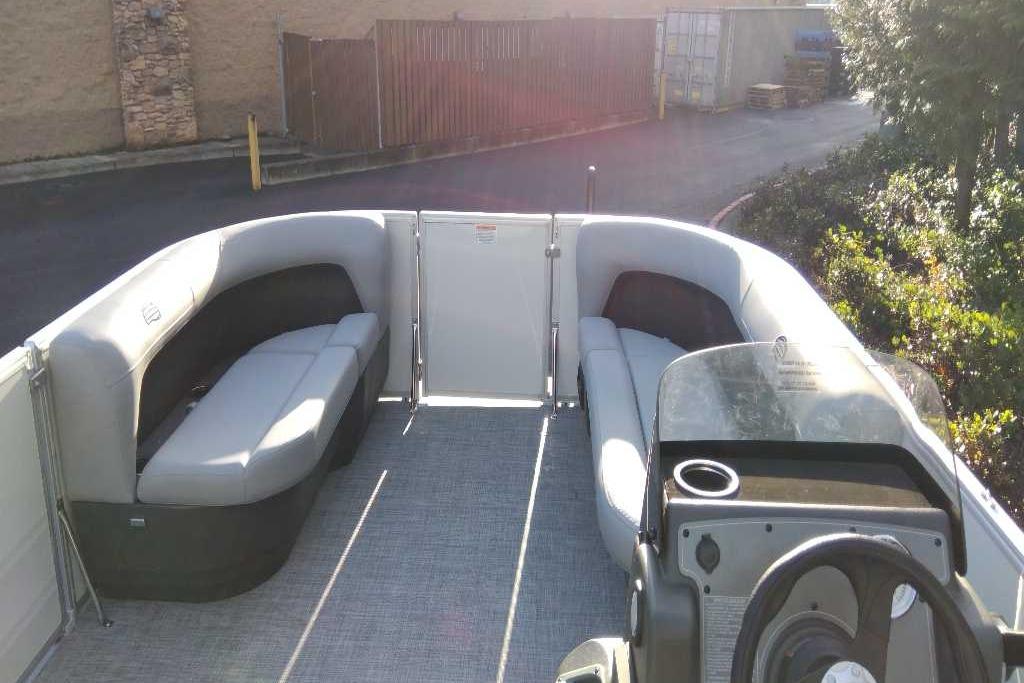2026 Sun Tracker Party Barge 16 DLX interior with seating and steering console.