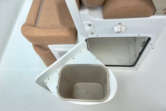 Interior of 2026 Sea Hunt Ultra 255 SE boat with storage compartment and seating.