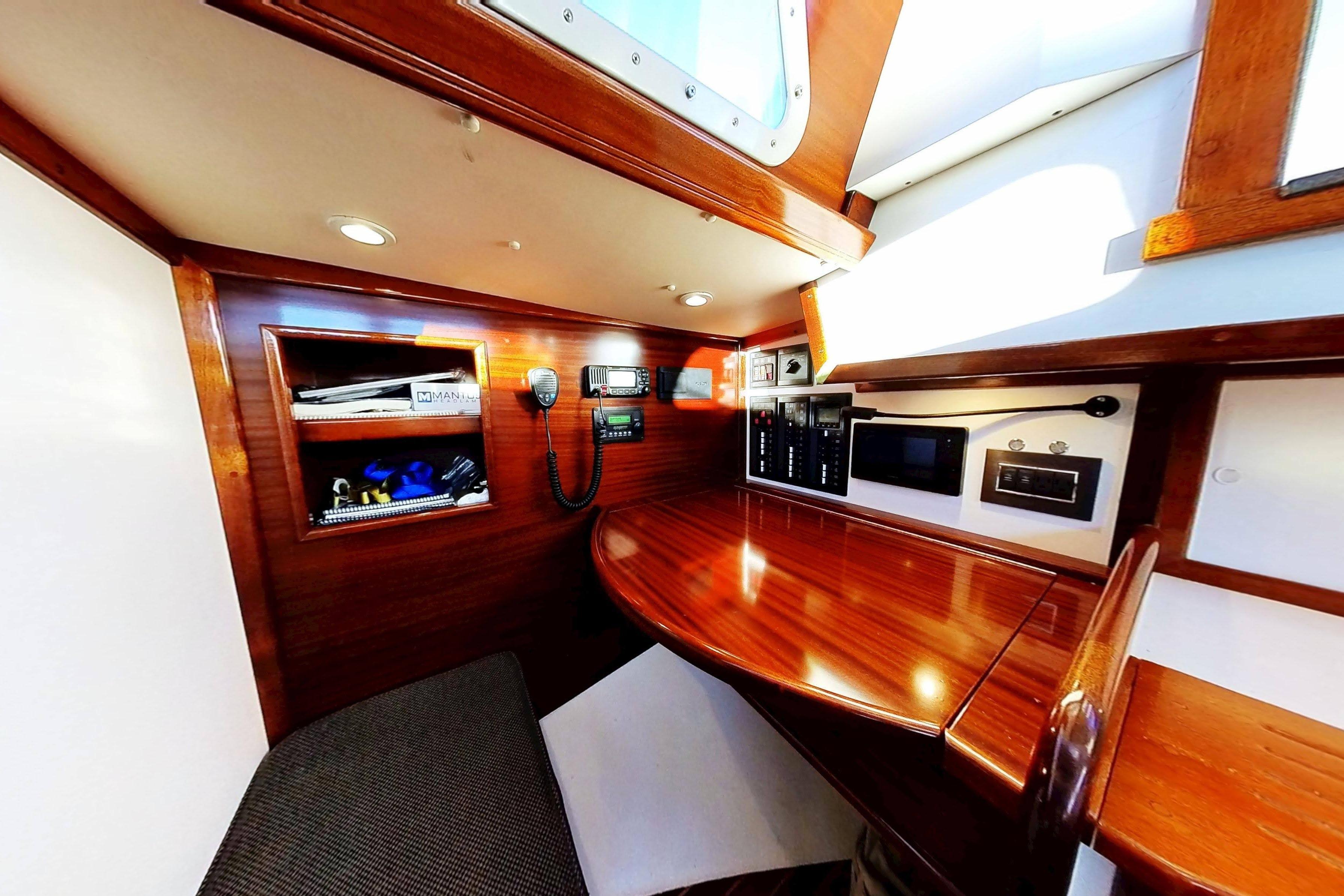 Interior of a 1970 Hinckley Bermuda 40 sailboat with polished wood and navigation equipment.
