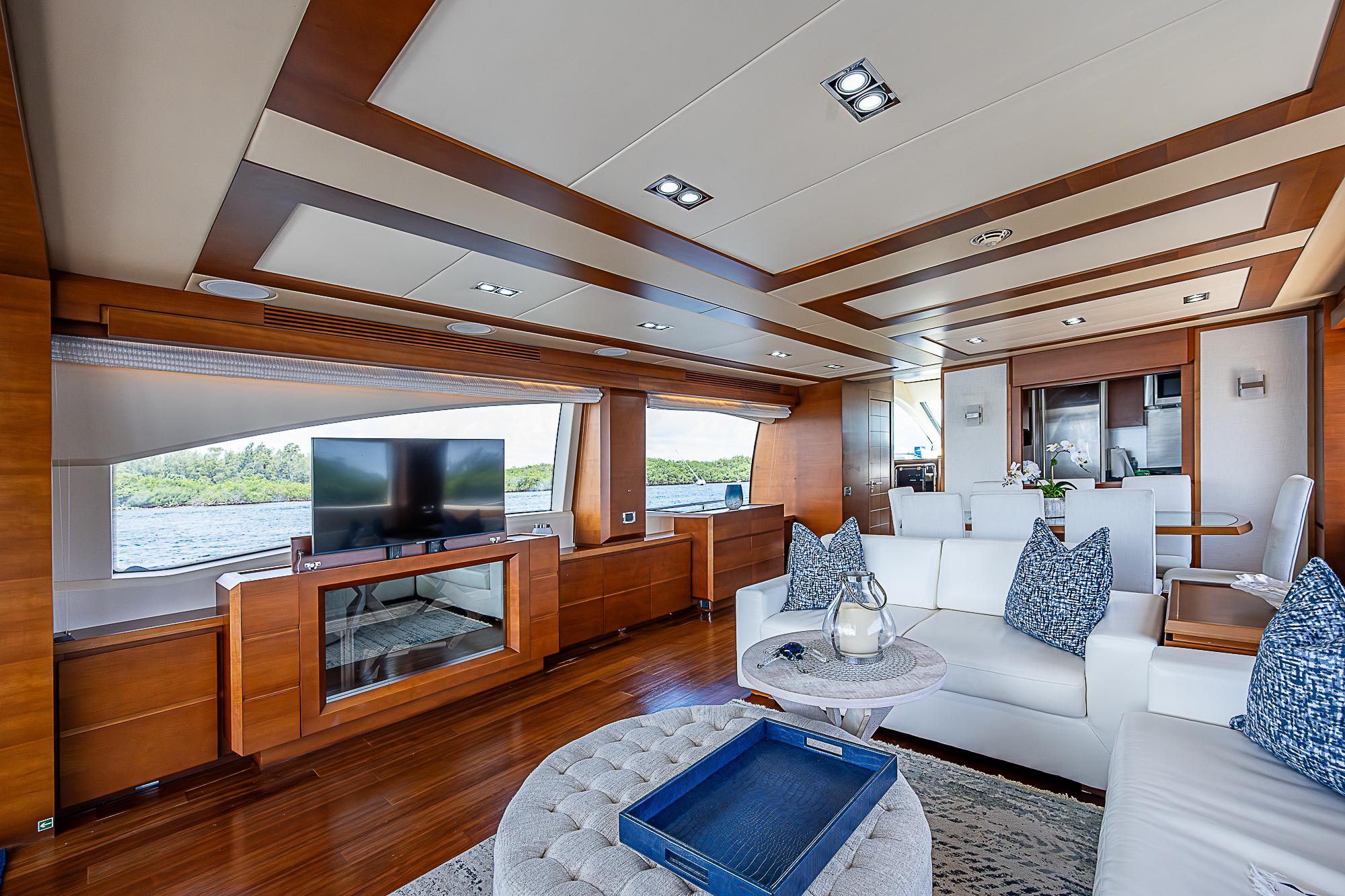 Luxurious interior of 2011 Azimut 82 yacht with modern furnishings and large windows.
