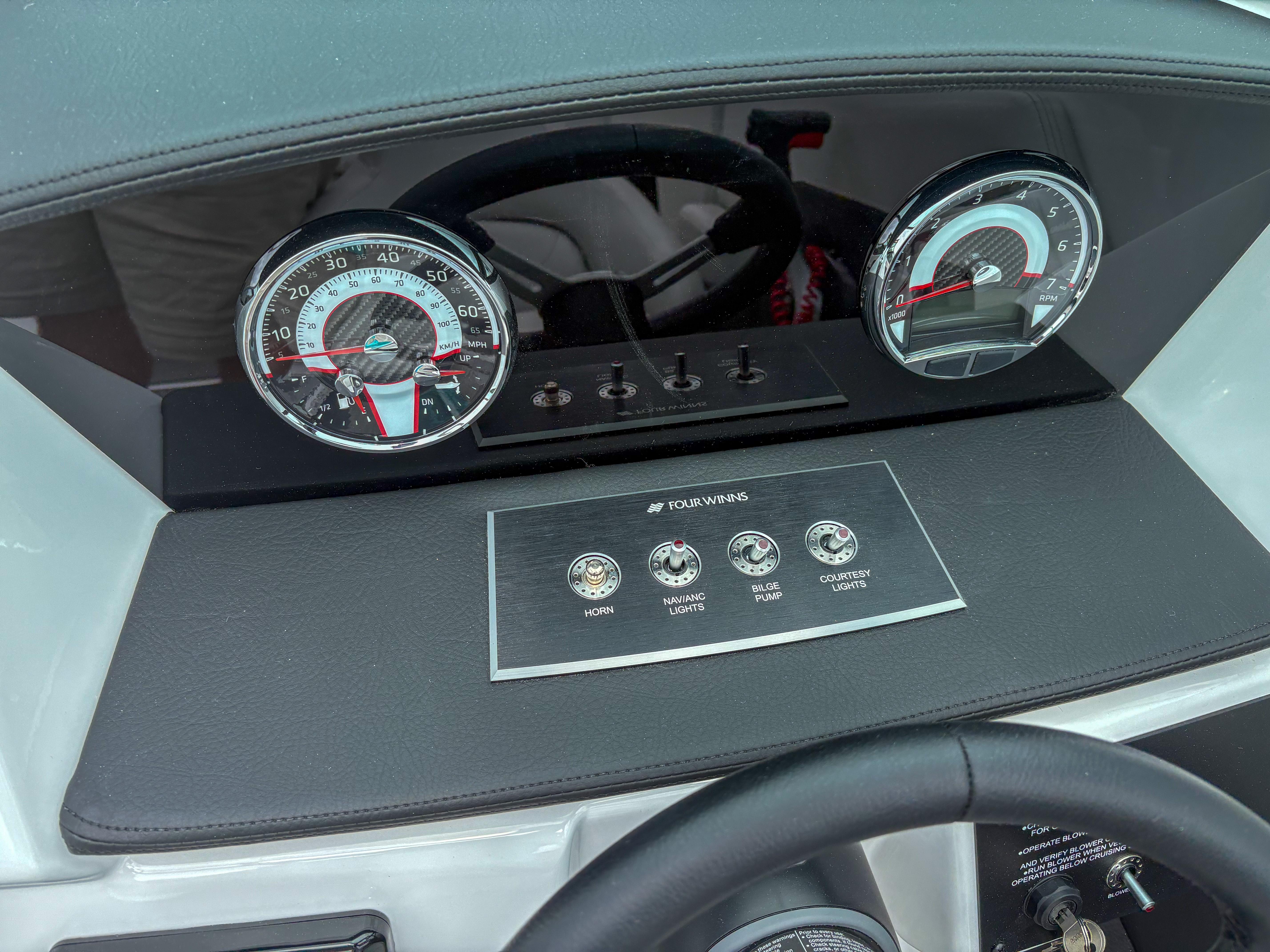 2026 Four Winns H2 Freedom dashboard with speedometer, RPM gauge, and control switches.