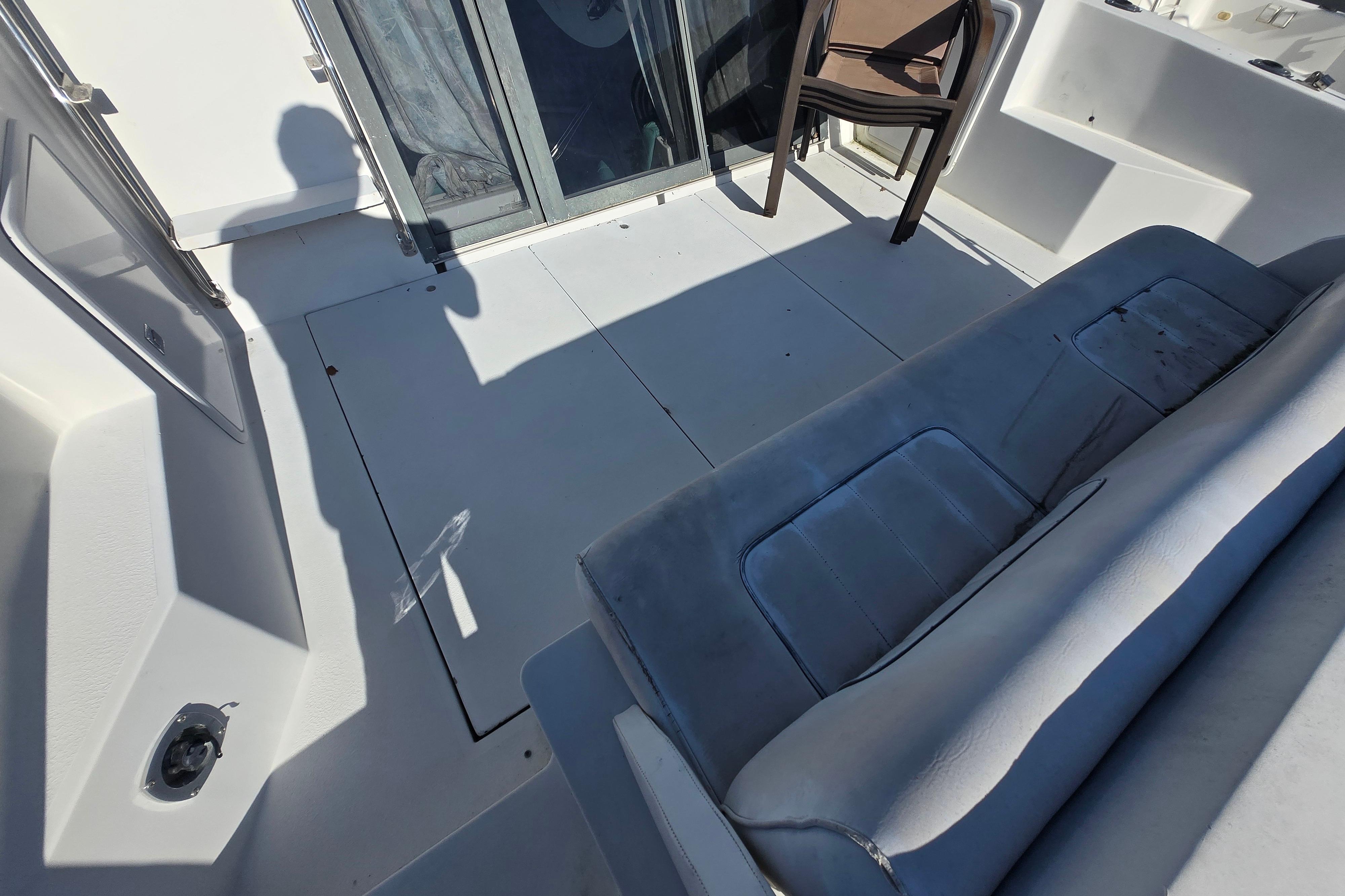 1994 Carver 380 Santego boat interior with seating and sliding glass door.