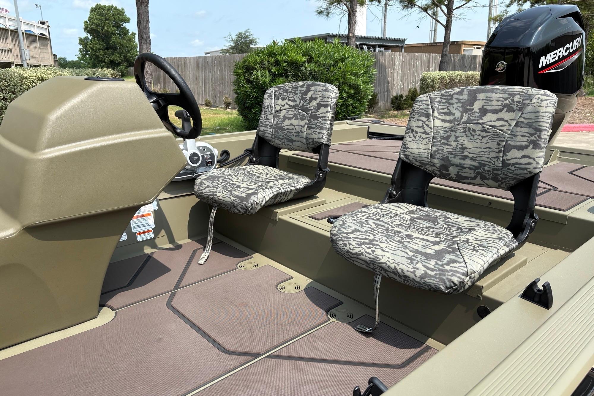 2026 Tracker Grizzly 1754 SC boat interior with camo seats and Mercury engine.