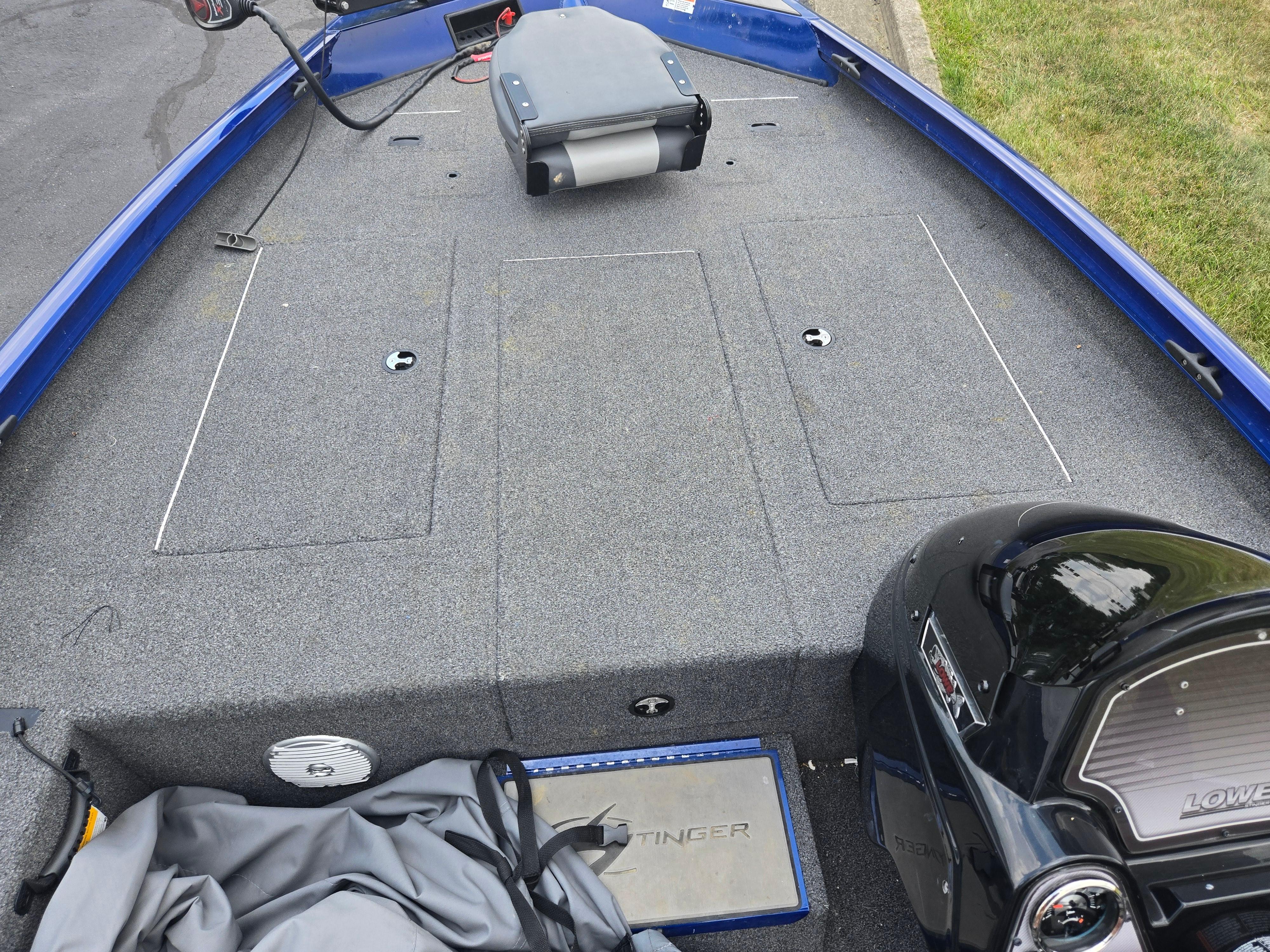 2021 Lowe Stinger 188 boat interior with gray carpet and blue trim.