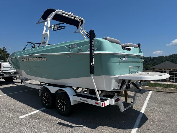 2025 Moomba Max boat on trailer in parking lot, sunny day.