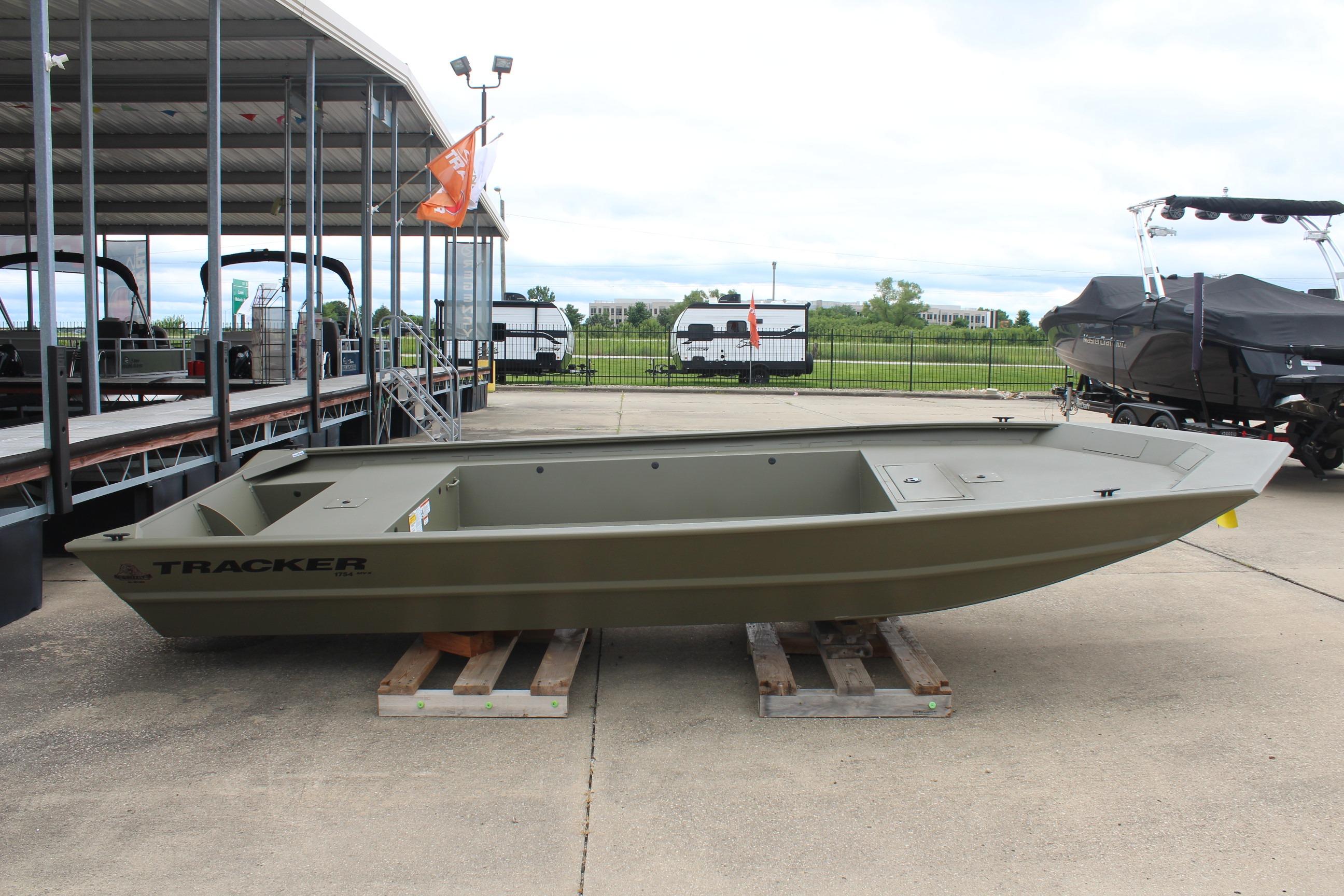 2026 Tracker Grizzly 1754 Utility boat displayed outdoors on wooden pallets.