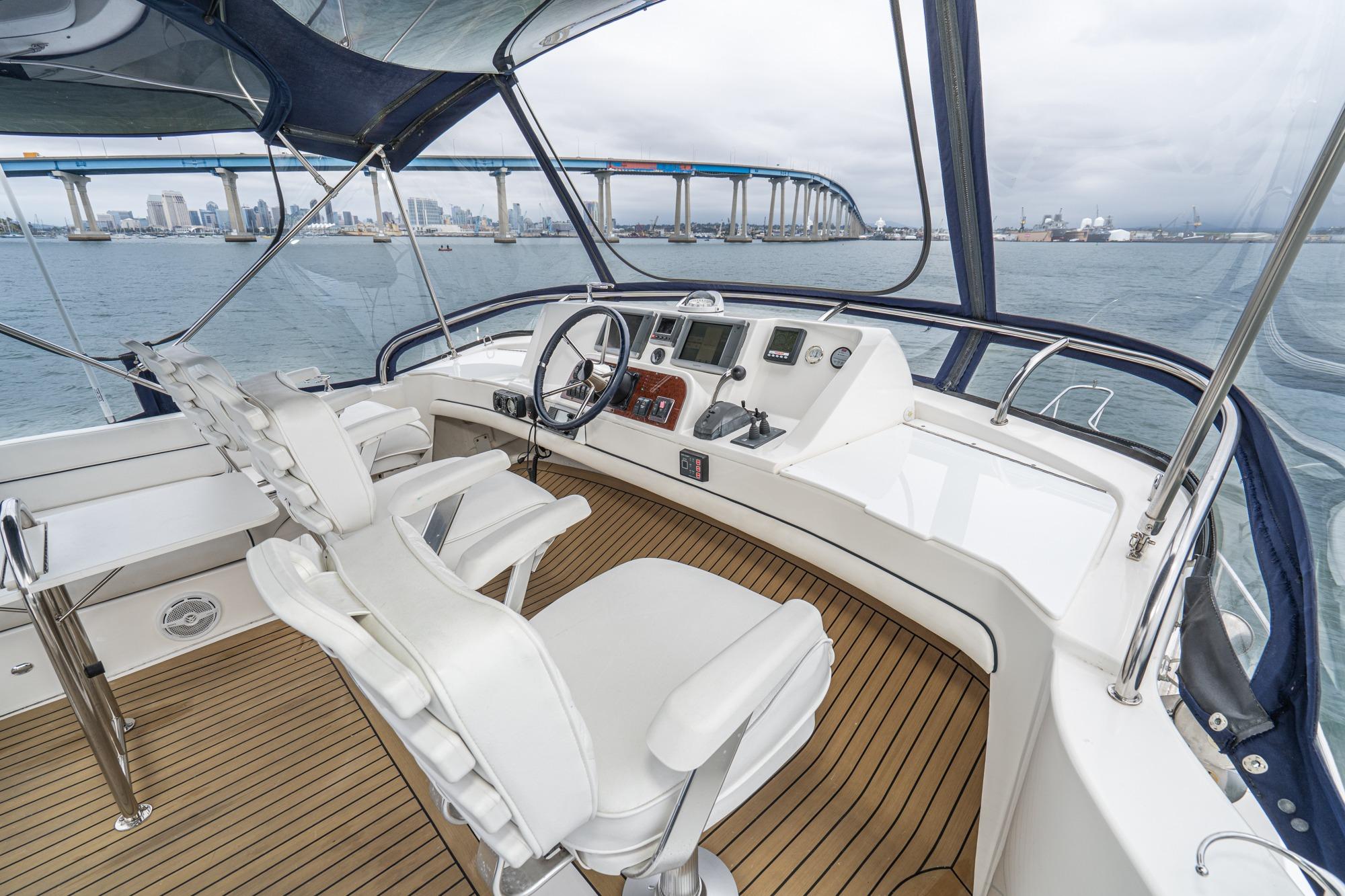 Helm of 2011 Mainship 395 Trawler with cityscape and bridge in background.