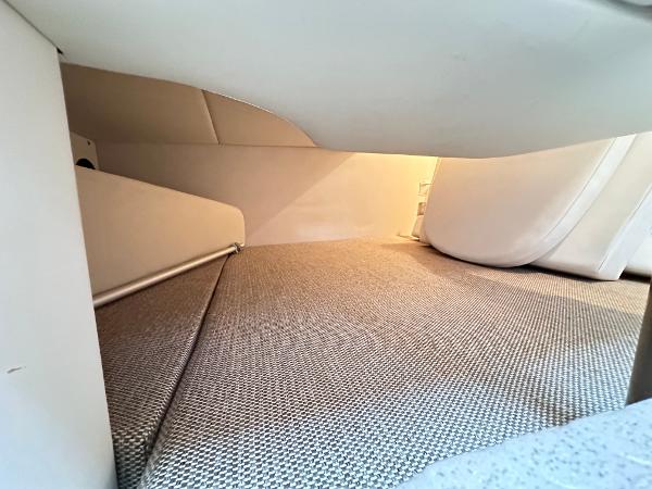 Interior cabin space of 2015 Sea Ray 260 Sundancer boat, featuring cozy sleeping area.