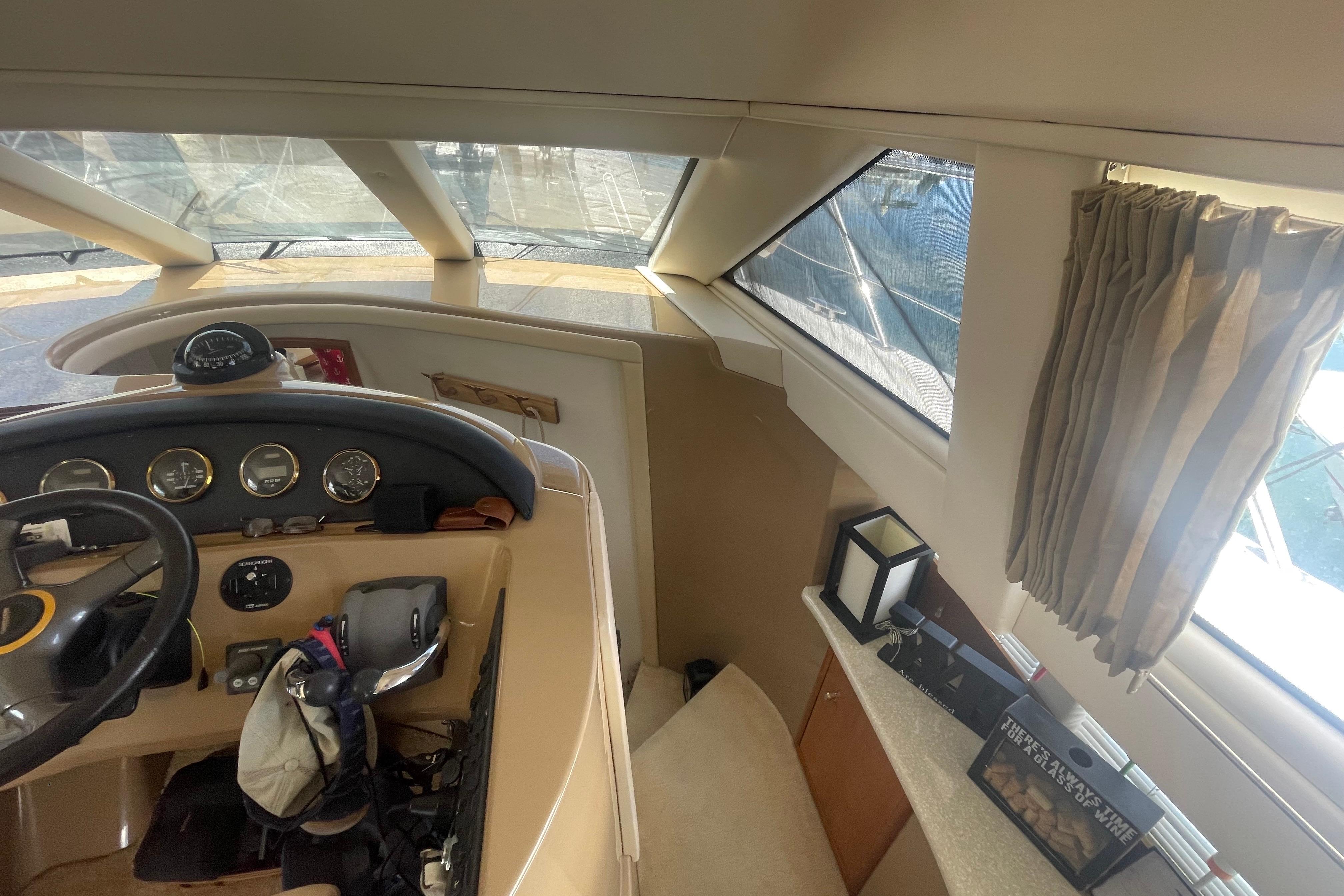 Interior view of 2002 Carver 410 Sport Sedan yacht cockpit with steering wheel and gauges.