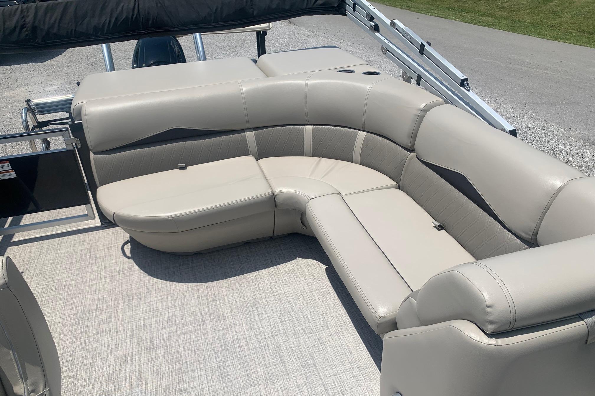 Luxurious seating on 2023 Silver Wave 2410 SW3 CLS pontoon boat, featuring plush beige upholstery.