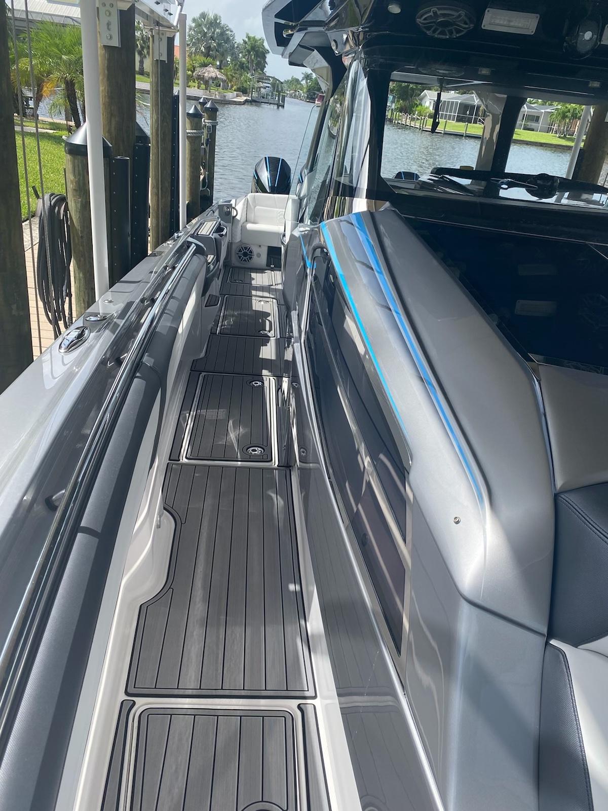 2025 Nor-Tech 450 Sport boat docked, showcasing sleek design and spacious deck.
