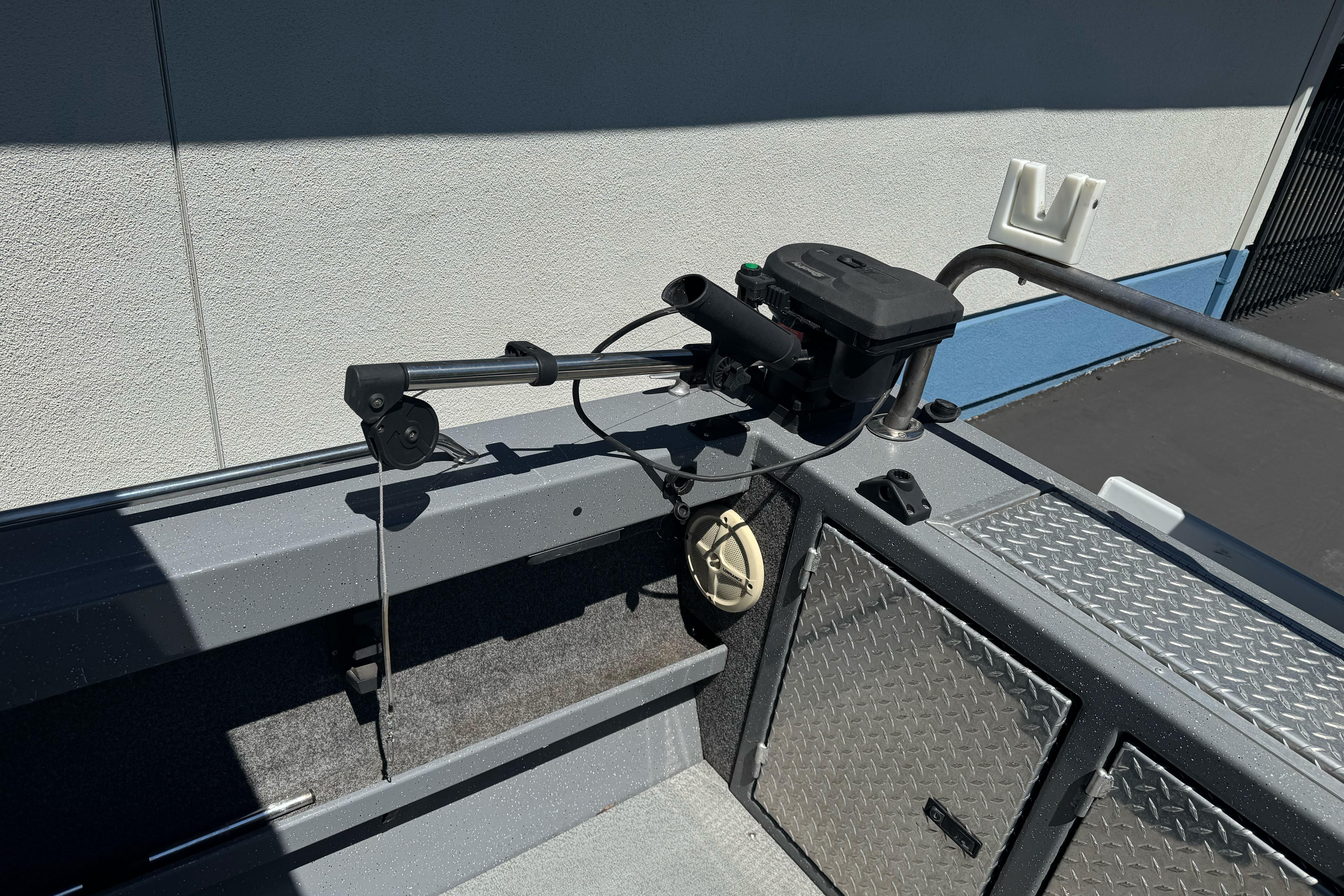 Interior of a 2014 River Hawk 19 GB boat featuring fishing equipment and storage compartments.