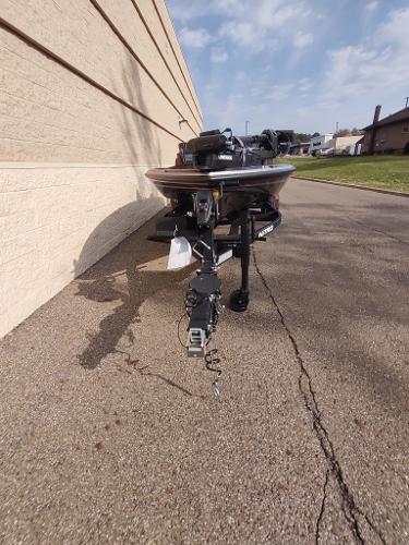 2024 Nitro Z21 XL boat parked on pavement beside a building.